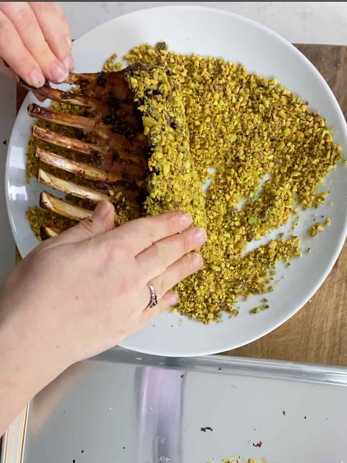 Press the crushed pistachios onto the rack of lamb.