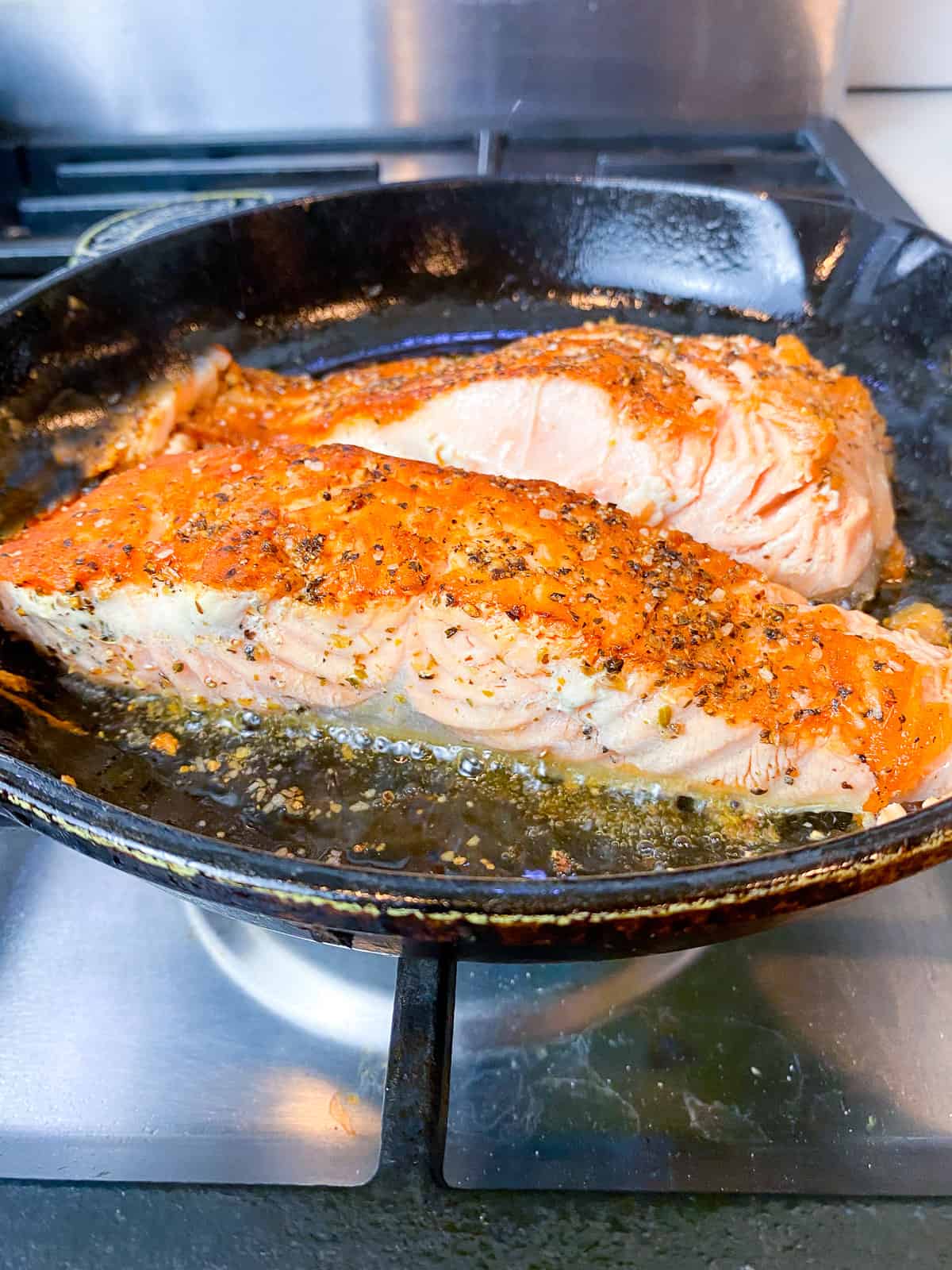 Sear the salmon filets in a hot skillet.