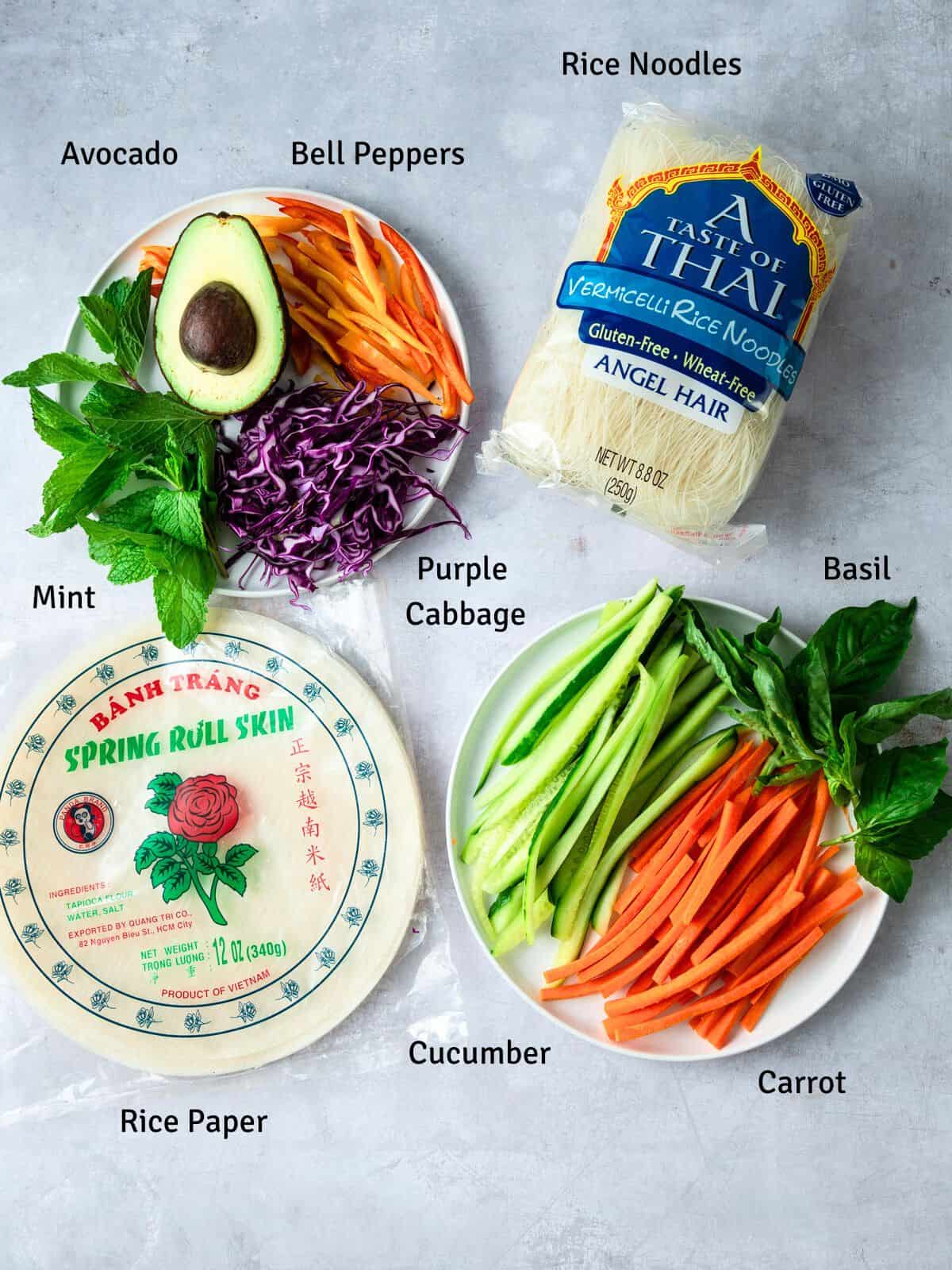 Ingredients for vegetable rice paper rolls, including avocado and rice noodles.