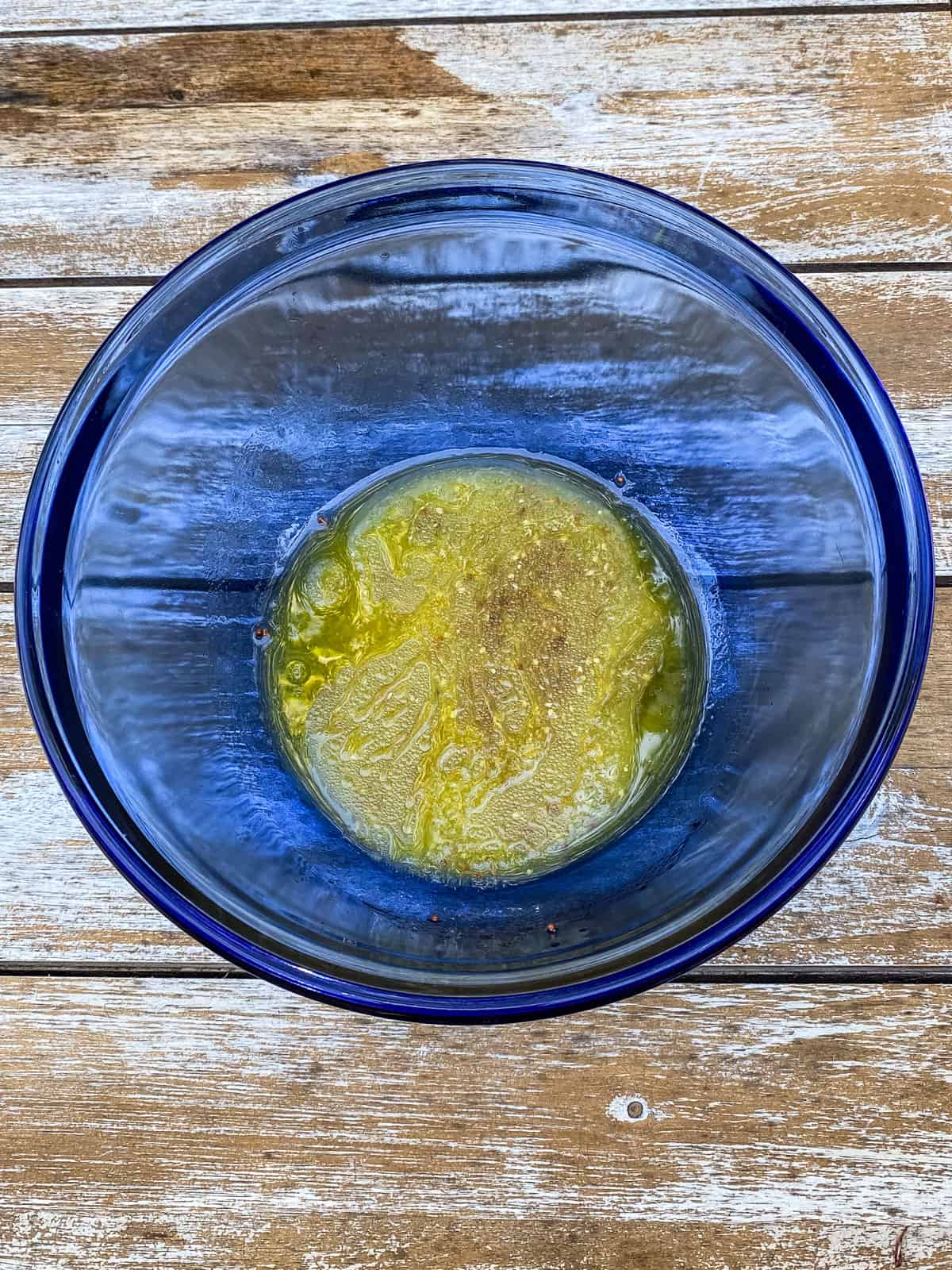 Whisk the mustard vinaigrette in the bottom of a bowl until emulsified.