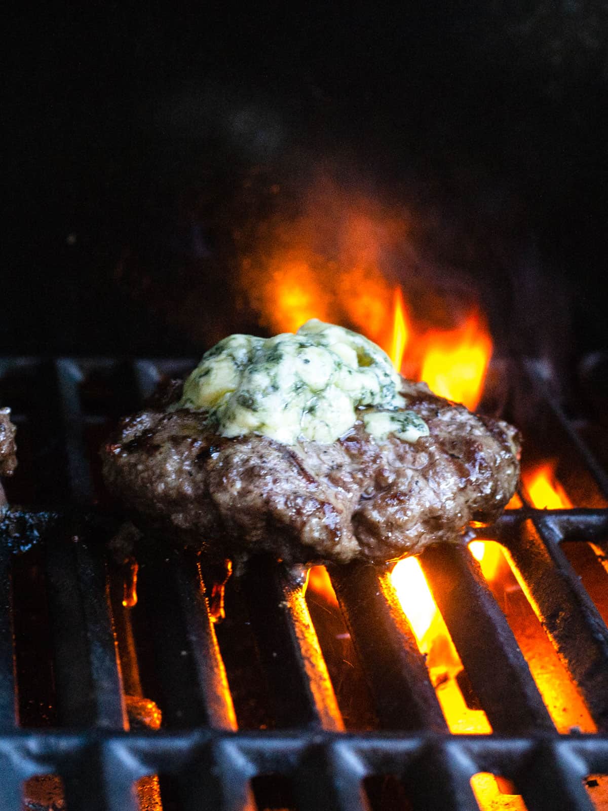 Top the grilled burgers with blue cheese for the last minute to melt the cheese slightly.