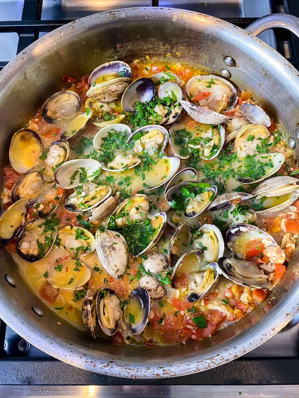 Add chopped fresh parsley as soon as the clams are done cooking.
