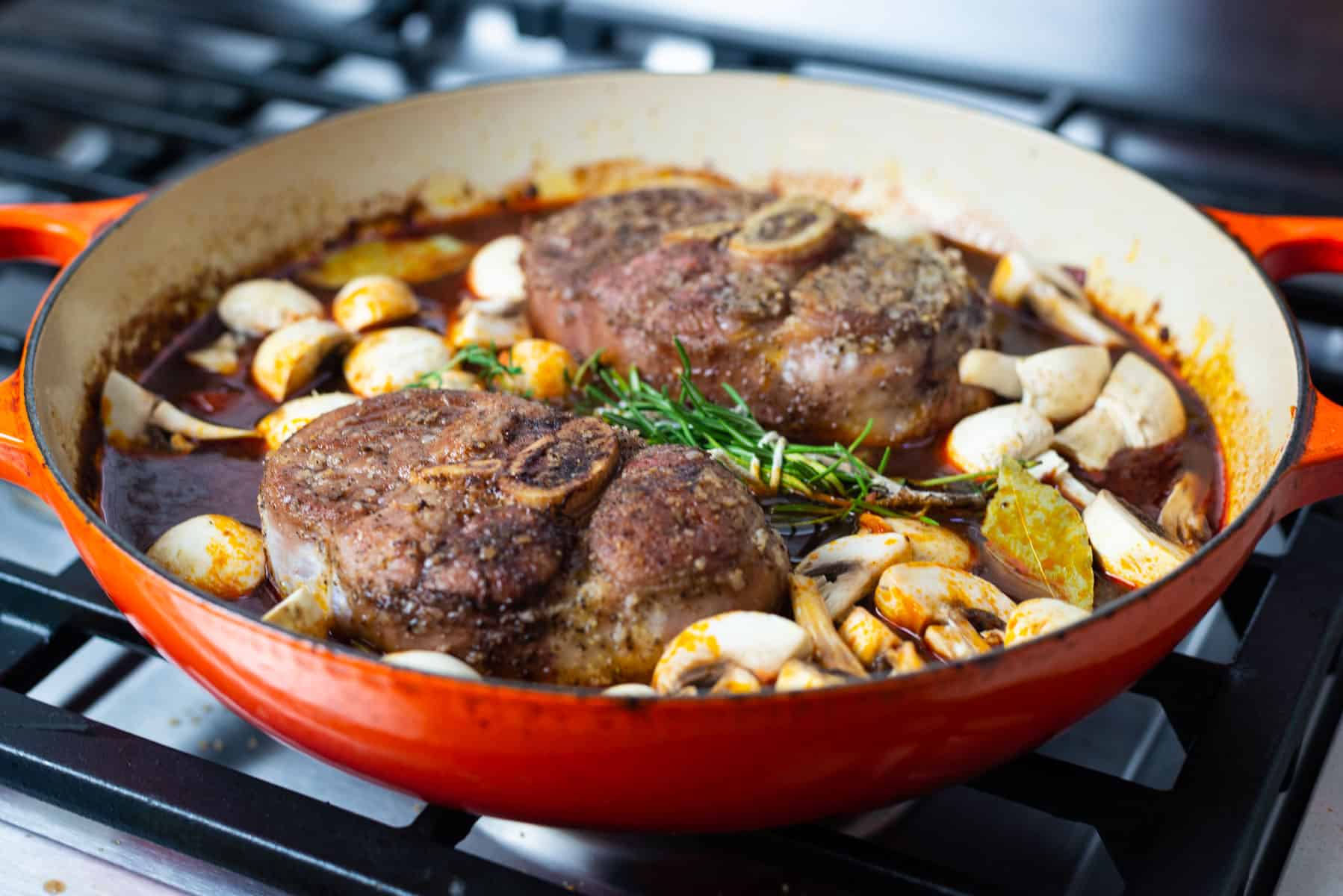 Add fresh herbs and mushrooms to the veal osso buco.