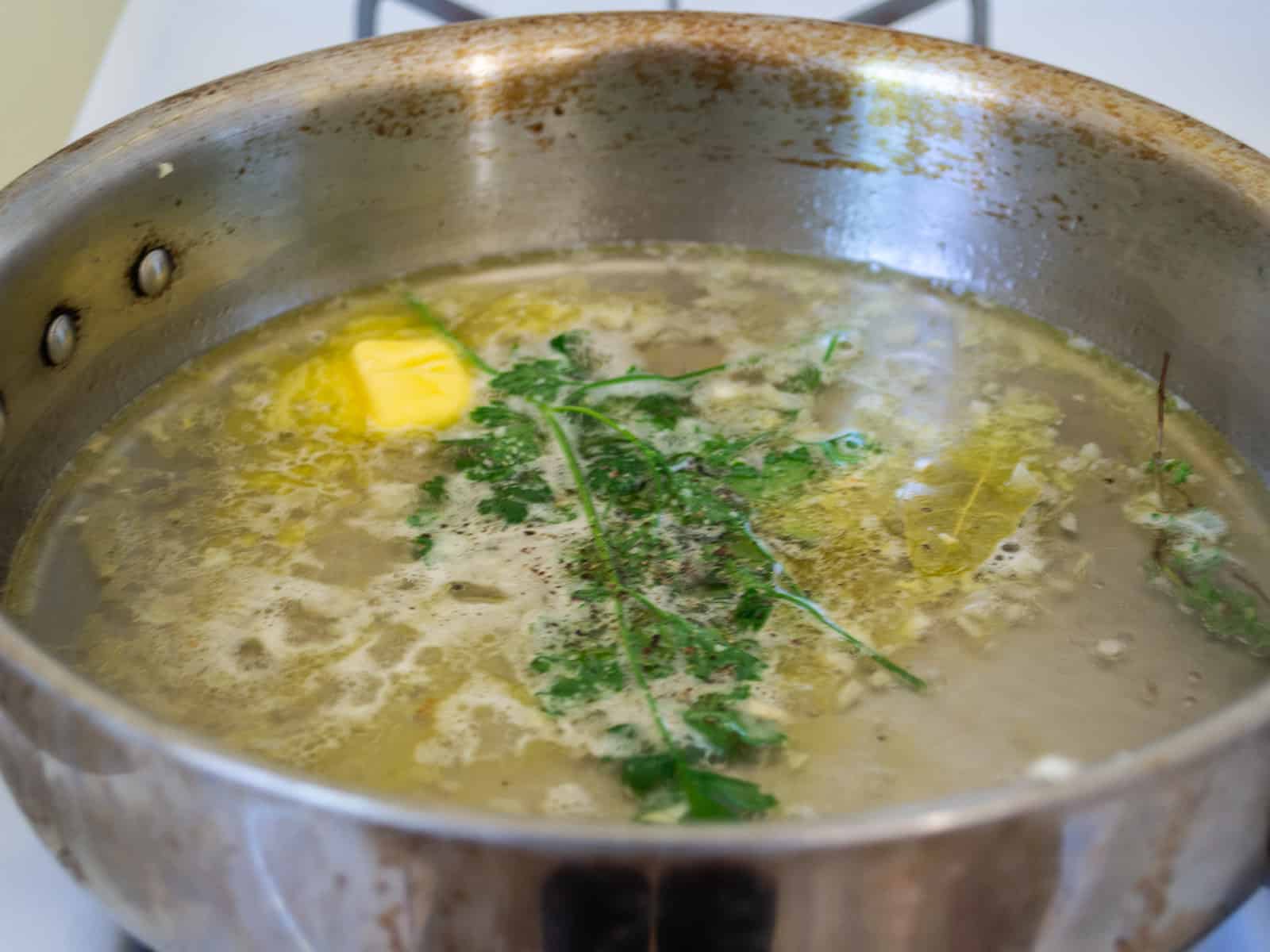 Simmer butter, shallots, wine, herbs and salt and pepper and bring to a boil.