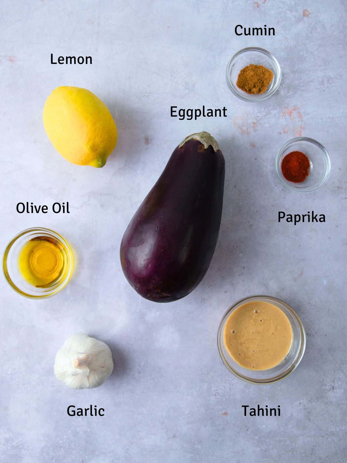 Ingredients for baba ganoush including tahini, garlic and paprika.