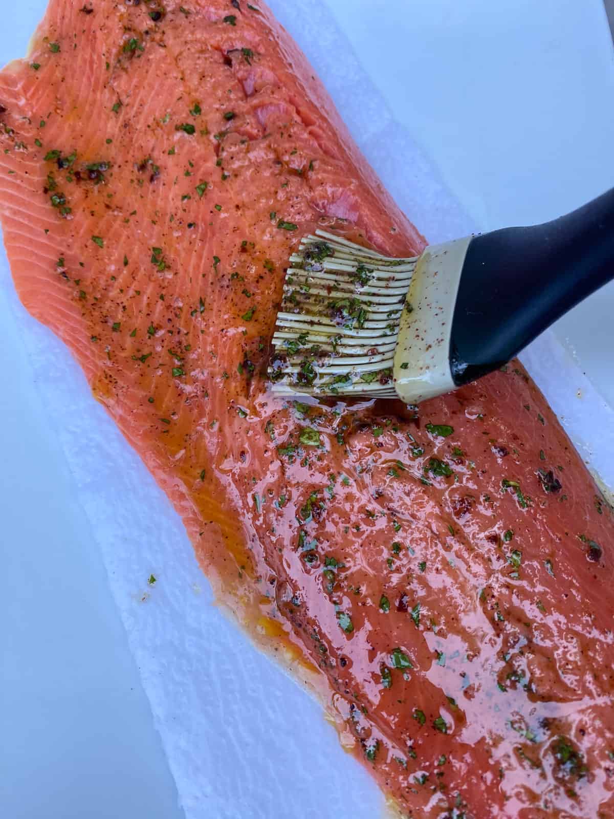 Brush the Mediterranean salmon marinade onto the salmon filet.