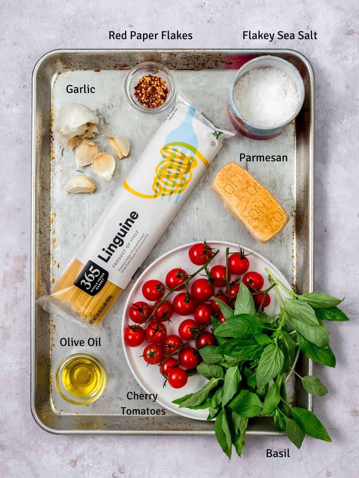 Ingredients for cherry tomato pasta with garlic and parmesan cheese.