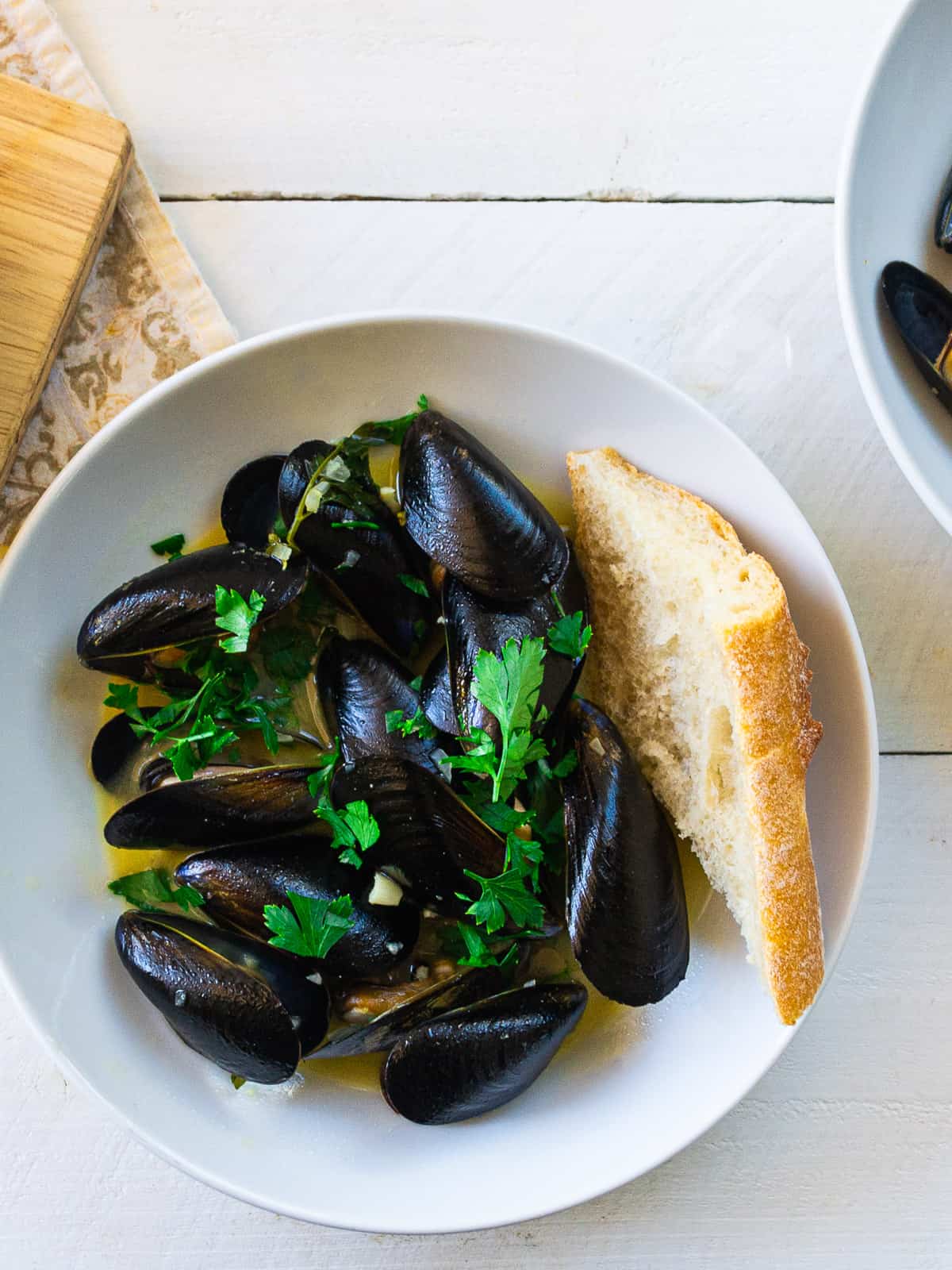 Mussels mariniere are steamed mussels flavored with herbs, butter, garlic and shallot.