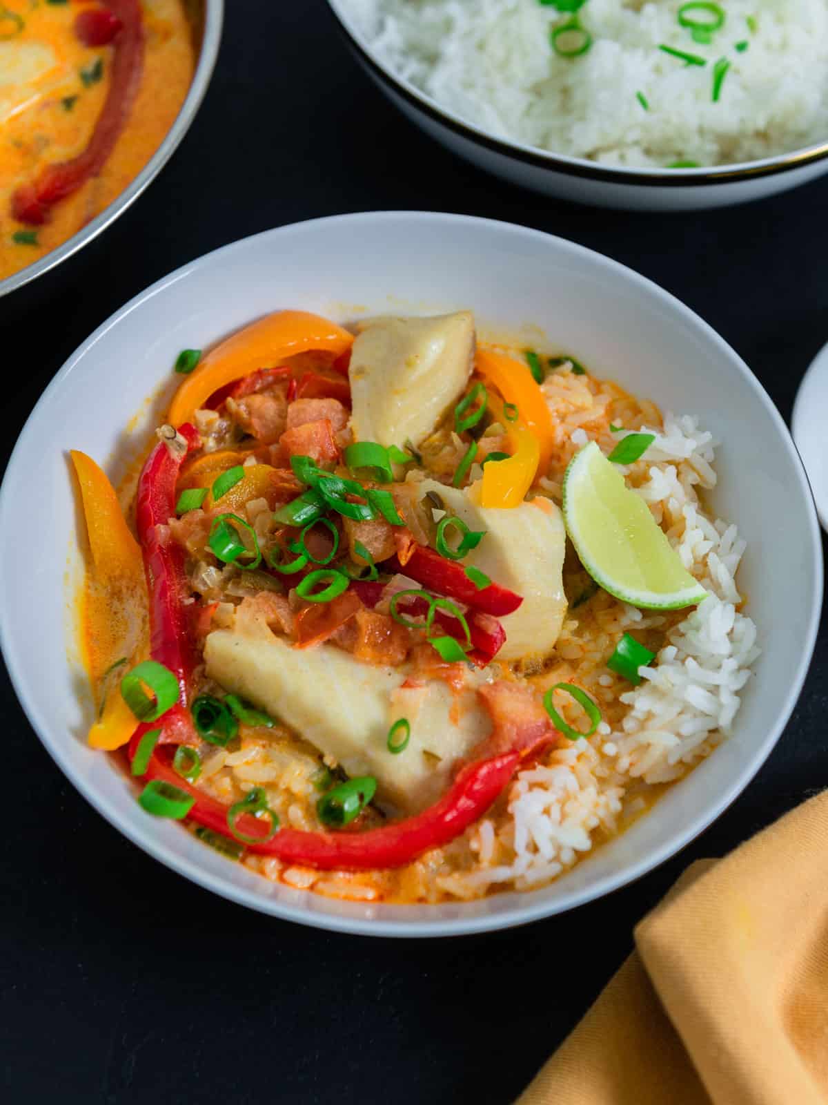 Serve moqueca with cooked Brazilian rice and lime wedges on the side.