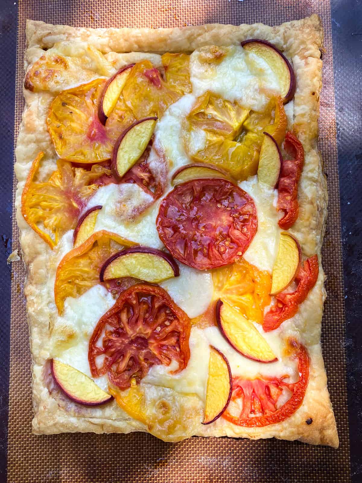 Bake the caprese tart until the puff pastry is golden brown and cheese has melted.