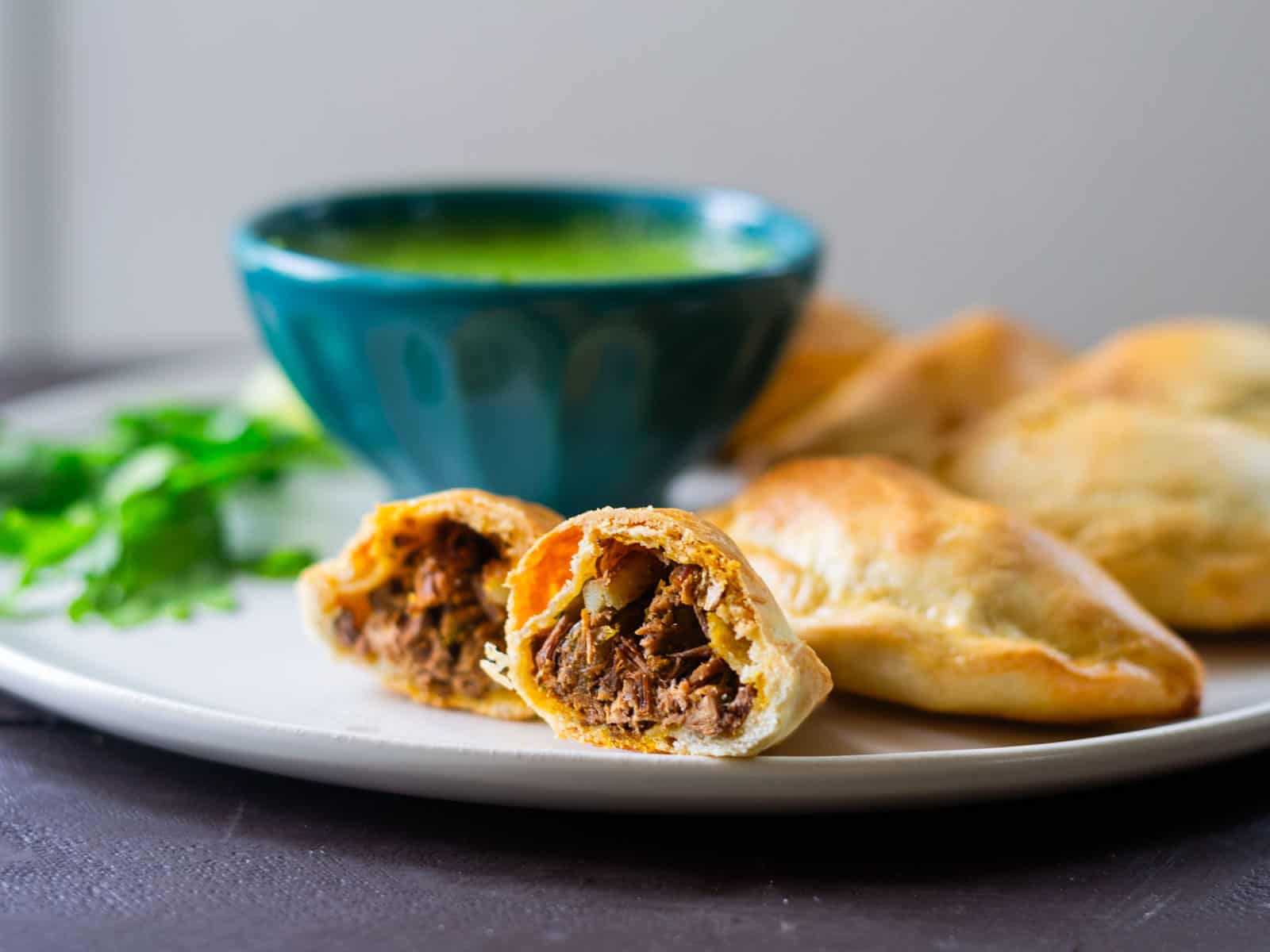 Baked empanadas filled with brisket and potatoes.