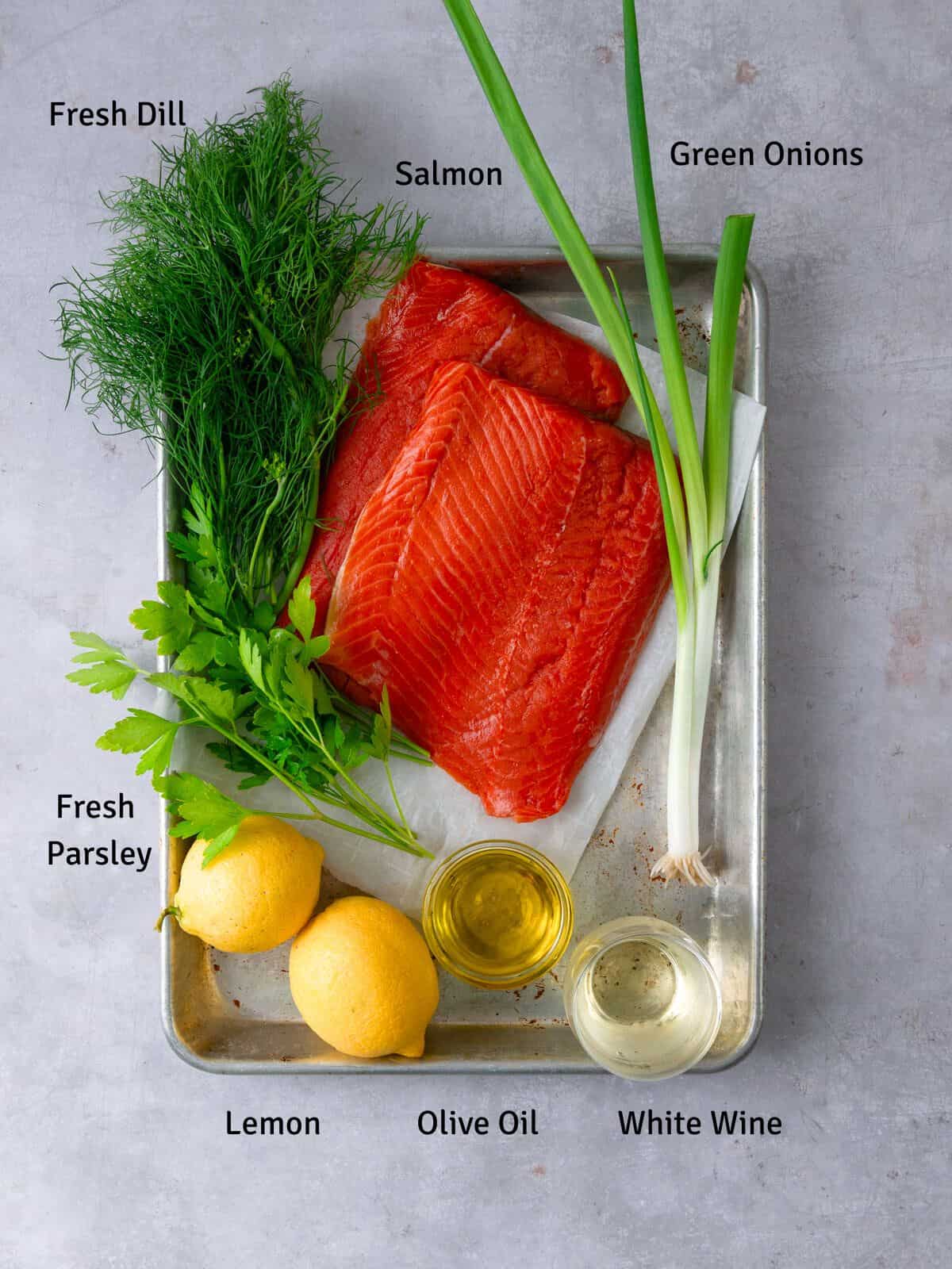 Ingredients for herb salmon with fresh herbs, lemon, white wine and olive oil.