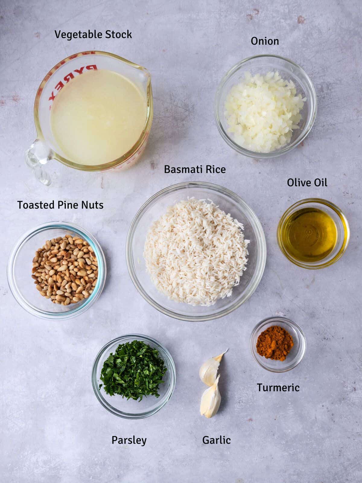 Ingredients for yellow Mediterranean rice, including basmati rice, olive oil and pine nuts.