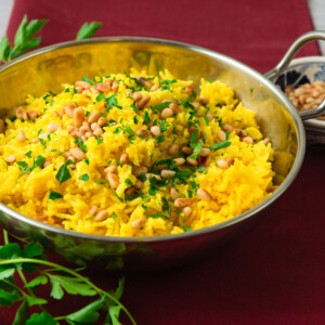 Mediterranean rice recipe with turmeric and toasted pine nuts.