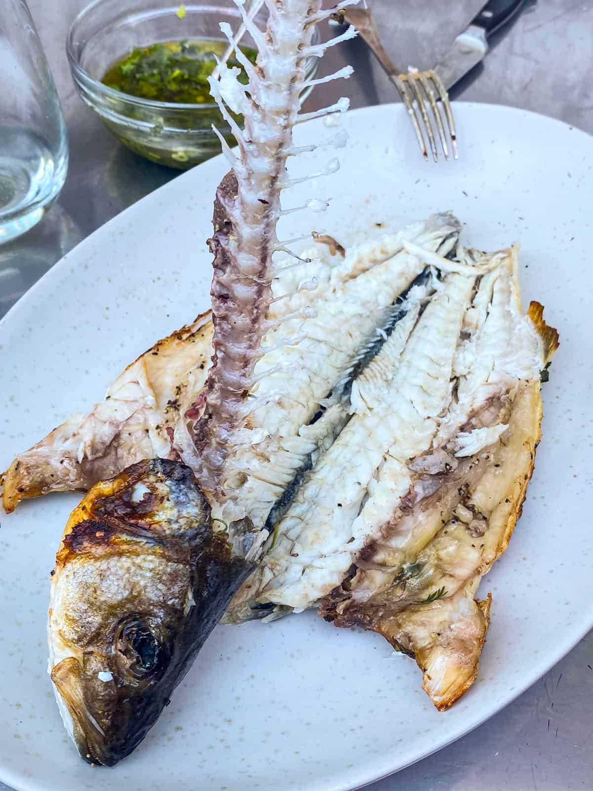 Remove the spine from the grilled branzino.