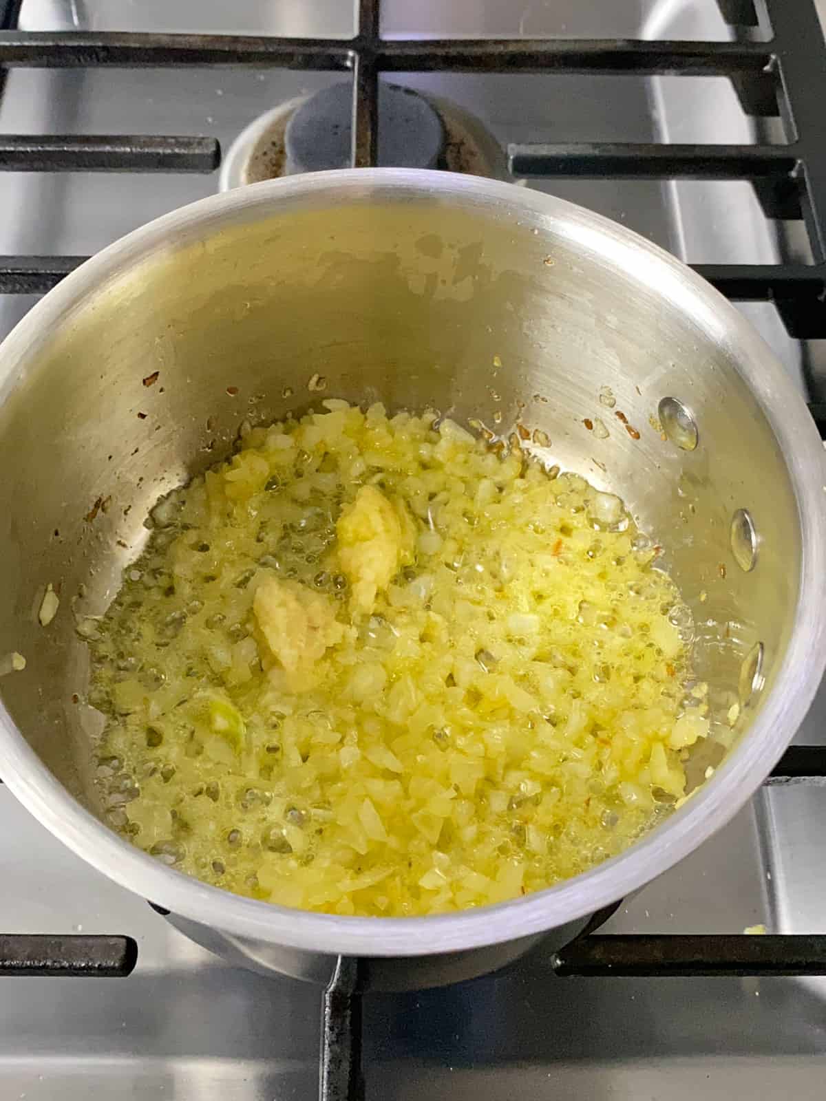 Saute chopped onion and garlic in olive oil until onion is softened and fragrant.