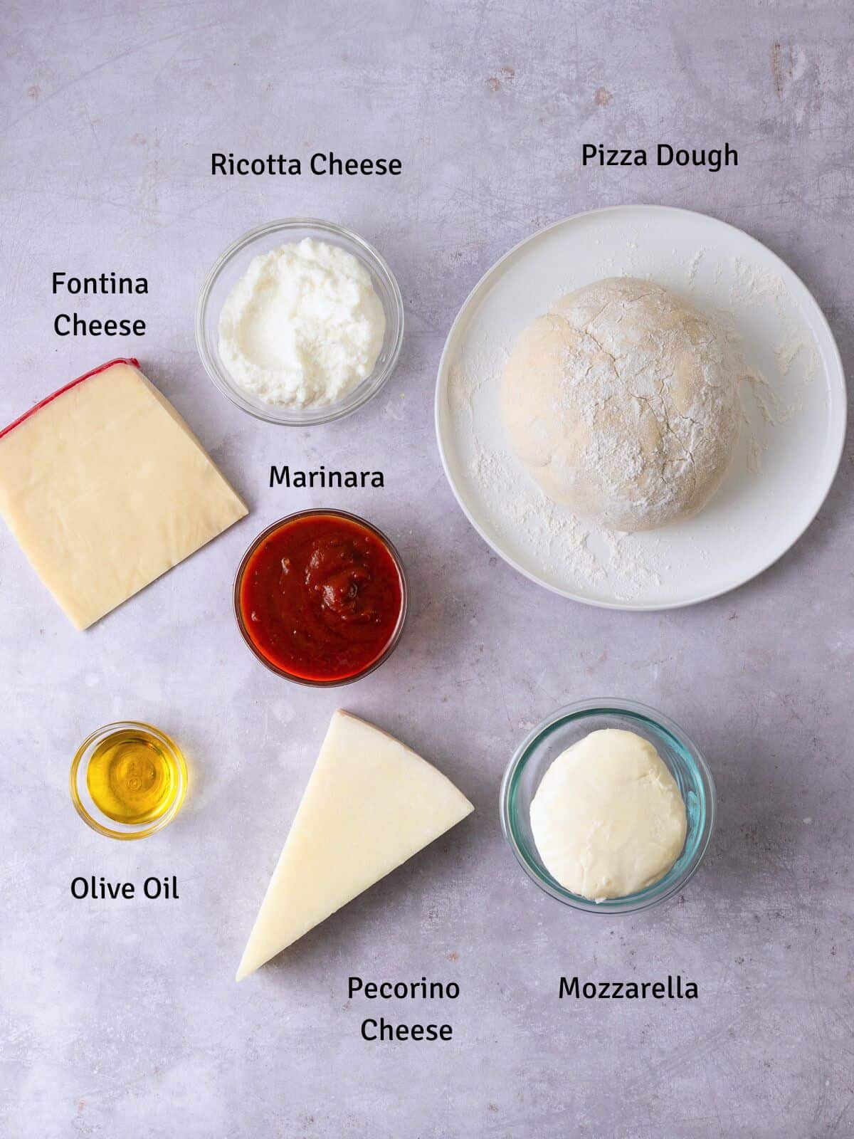Ingredients for cheese calzone including pizza dough and four cheeses, pecorino, mozzarella, fontina and ricotta cheese.