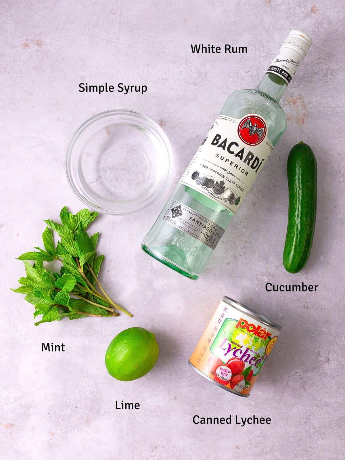 Ingredients for lychee mojito with fresh mint and simple syrup.