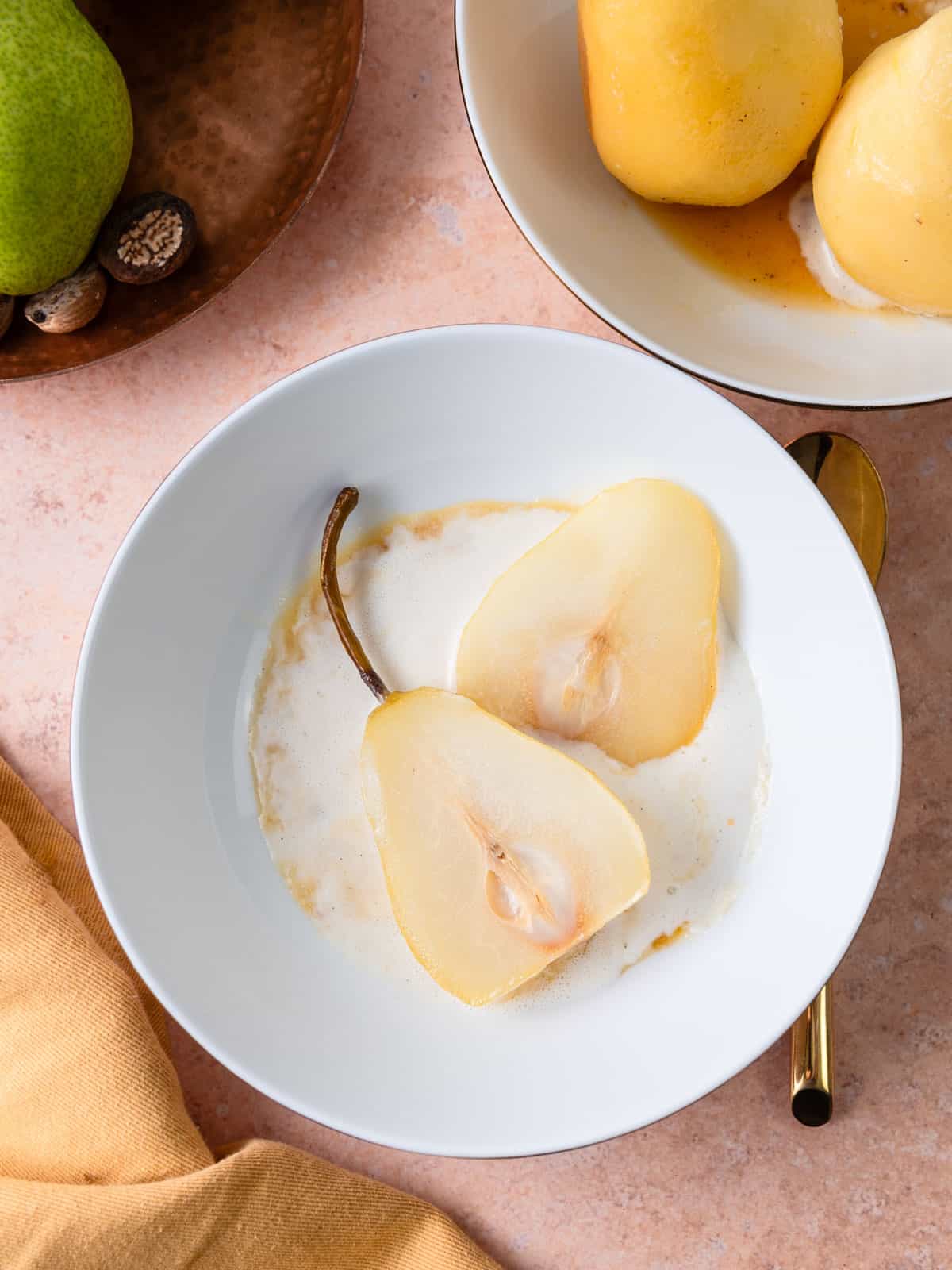Poached pears cut in half and served with vanilla ice cream.