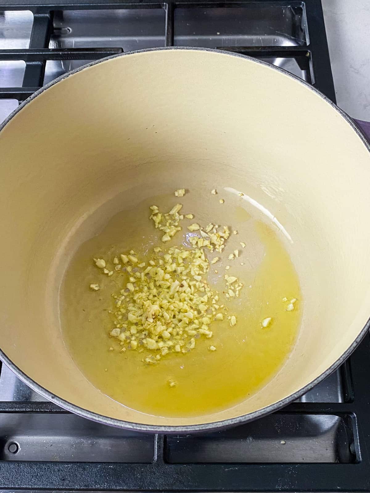 Saute chopped garlic in olive oil until fragrant.