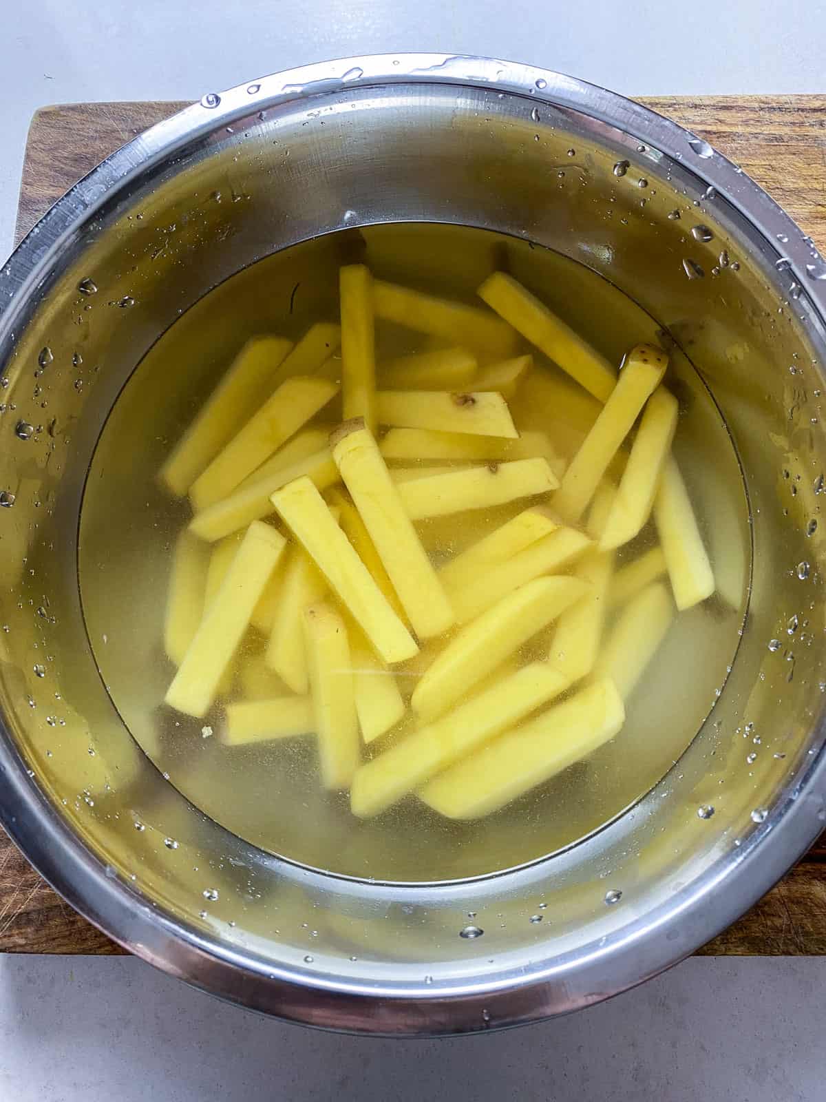 Soak the cut potatoes in a bowl of water.