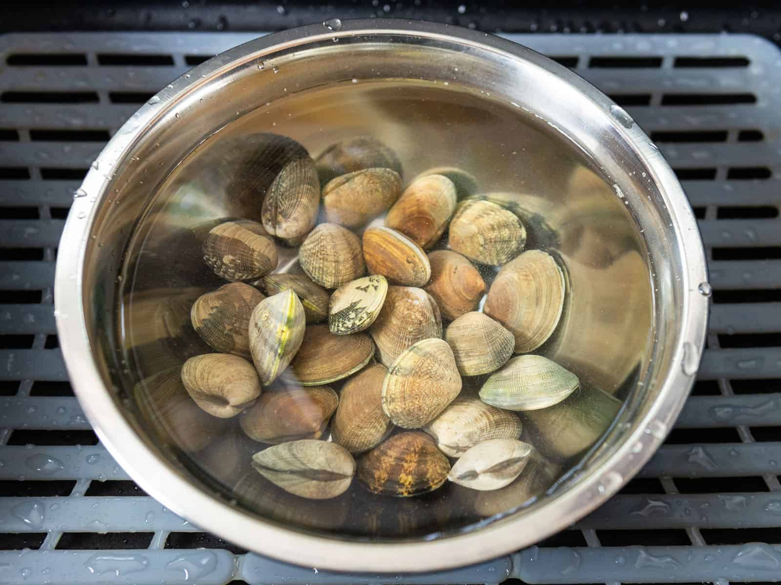 Soak the fresh clams in salted cold water to help purge any sand out.