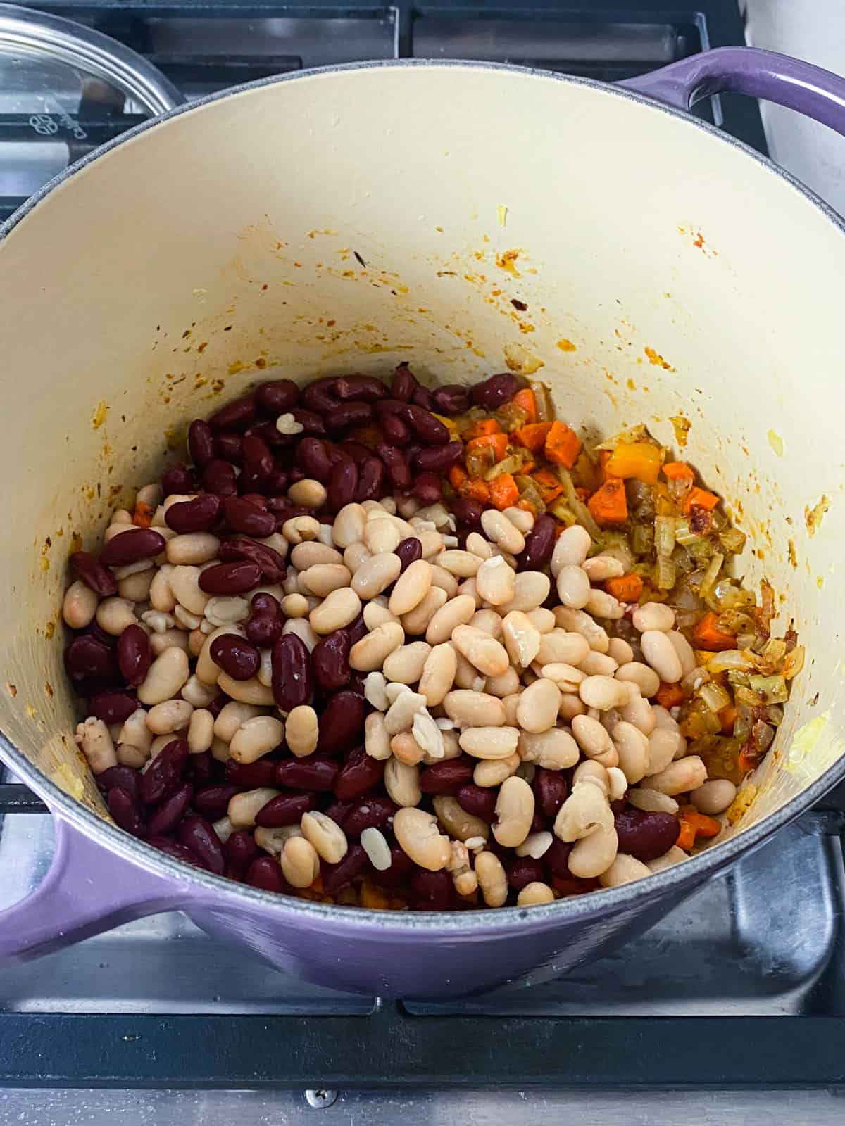 Add kidney beans and white beans to the vegetables.