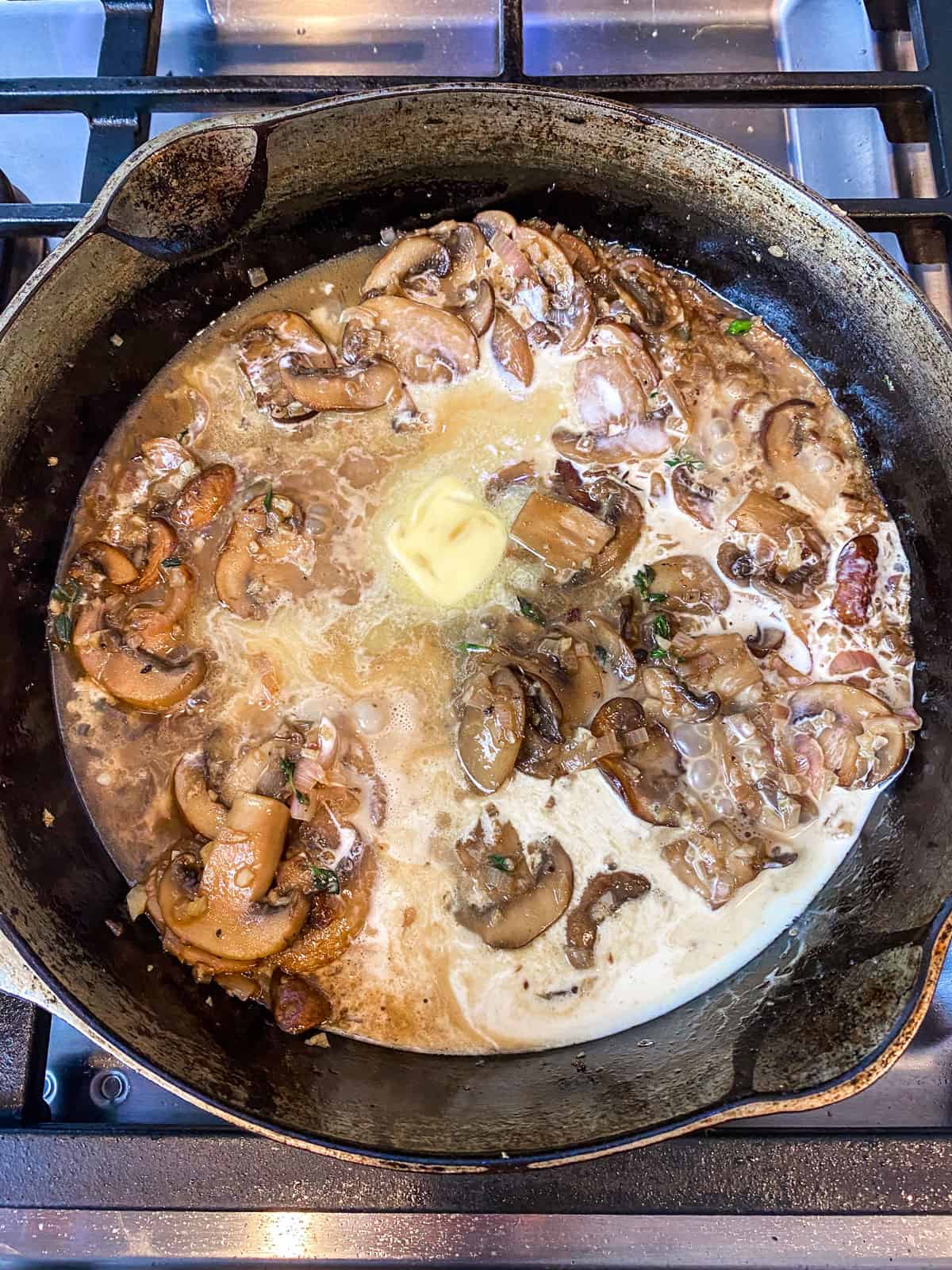 Add cream and butter to the sautéed mushrooms.