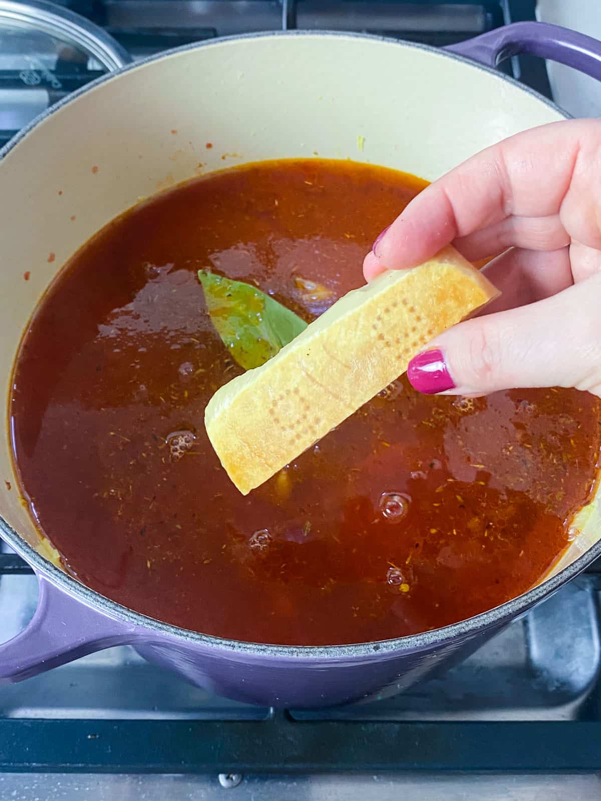 Add a good sized chunk of parmesan rind to the soup.