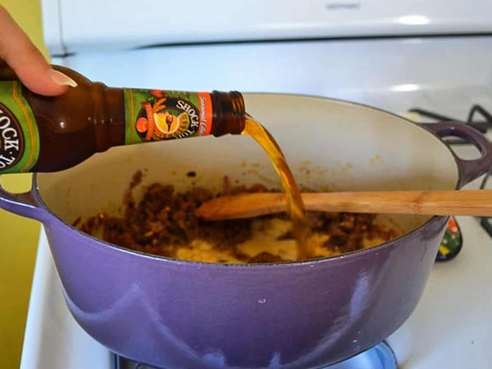 Pour a bottle of pumpkin beer into the cooked beef and let the beer reduce slightly.