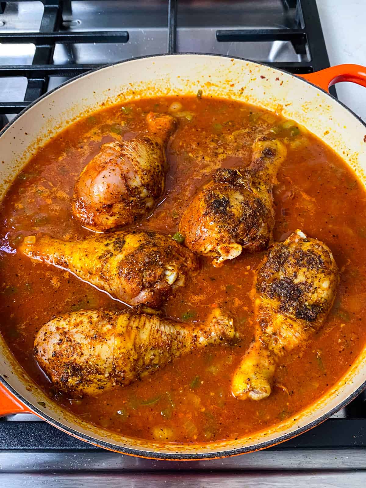Add the seared chicken to the tomato and stock mixture.