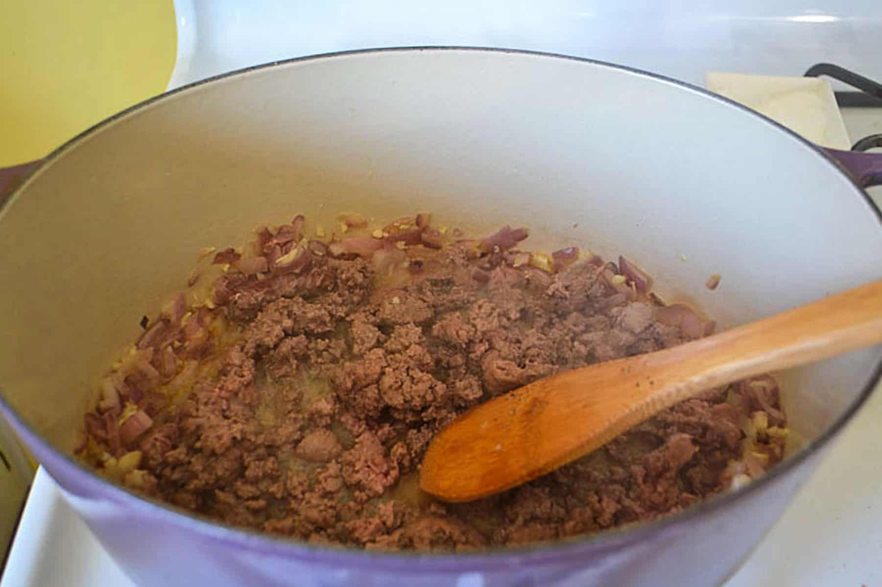 Cook the ground beef until charred on the outside and cooked all the way through.
