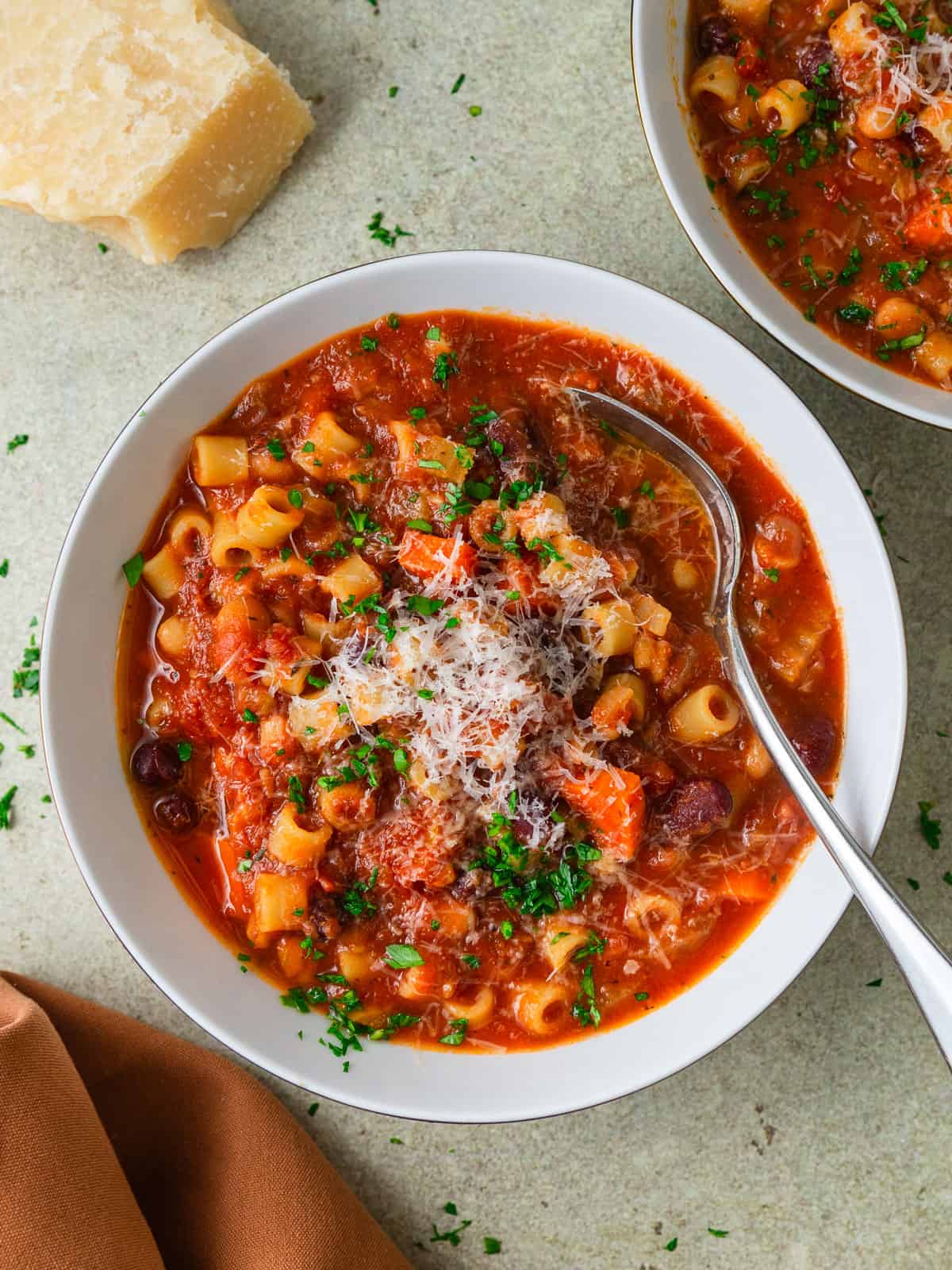 Easy recipe for vegetarian pasta fagioli that is full of hearty beans and vegetables and garnished with grated parmesan cheese.
