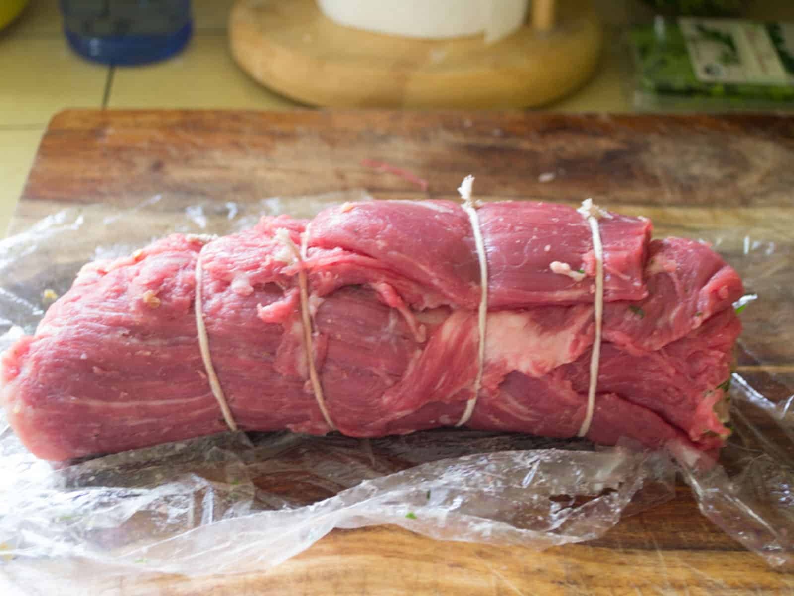 Roll the flank steak up, making sure the filling stays inside and use butcher string to tie up the braciole.