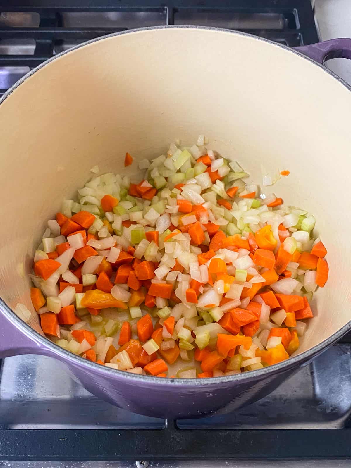 Drizzle a soup pot with olive oil and add chopped onions, chopped celery and chopped carrots and saute.