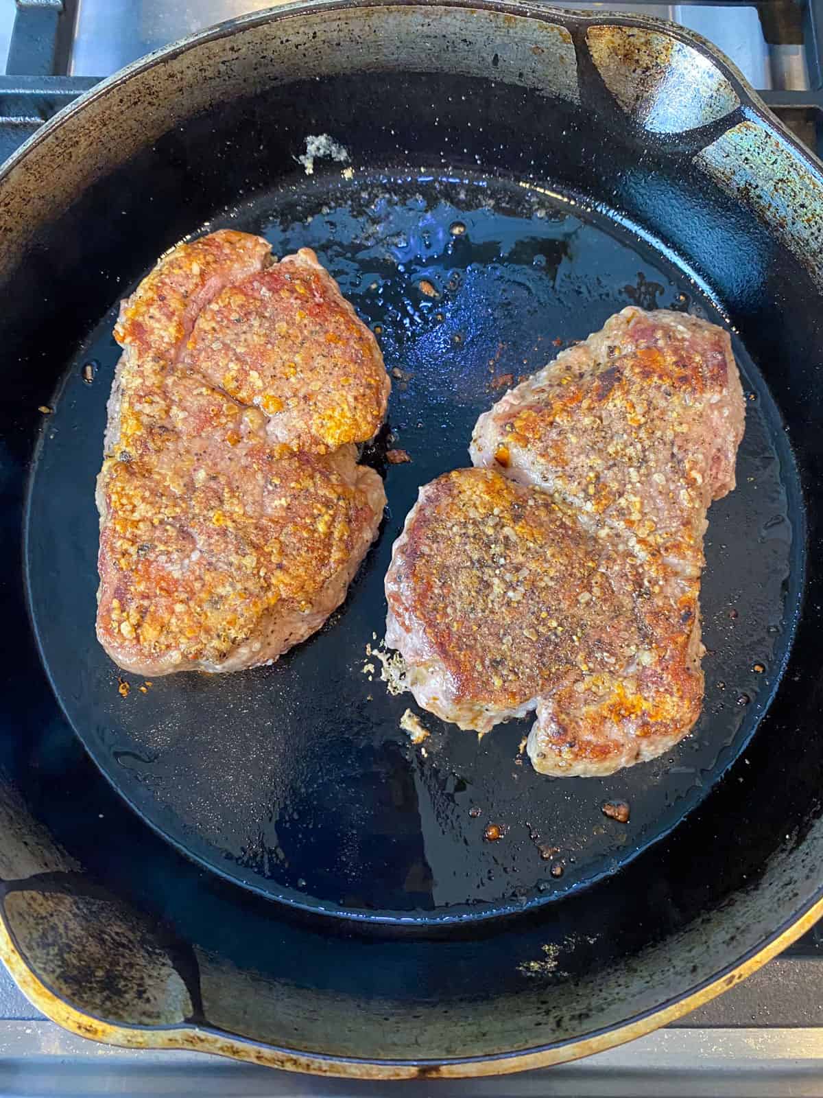 Sear the filet mignon in a hot cast iron skillet until deeply seared on both sides, but no cooked all the way through.