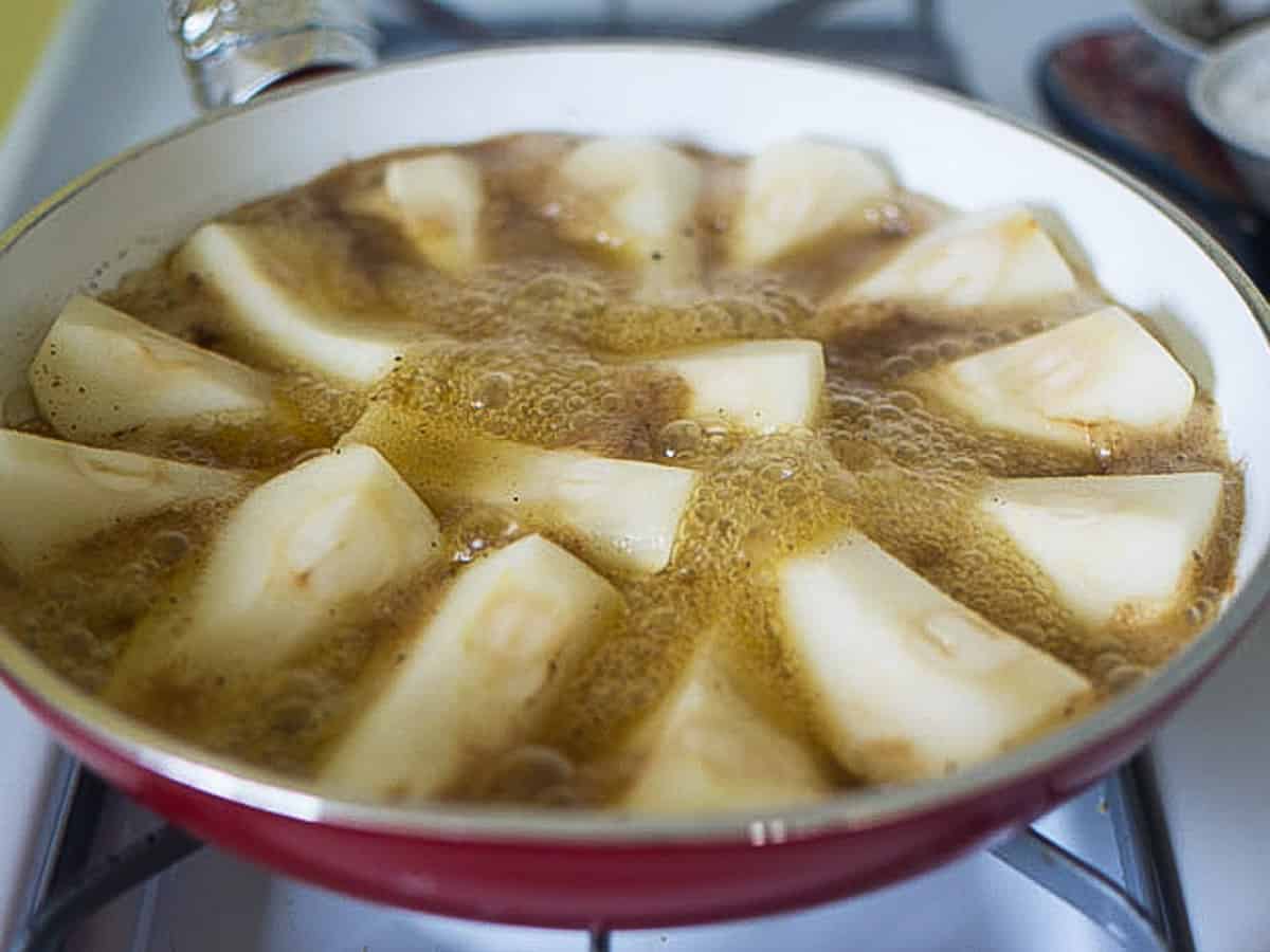 Simmer the pear wedges in the butter and caramel until they begin to just soften.