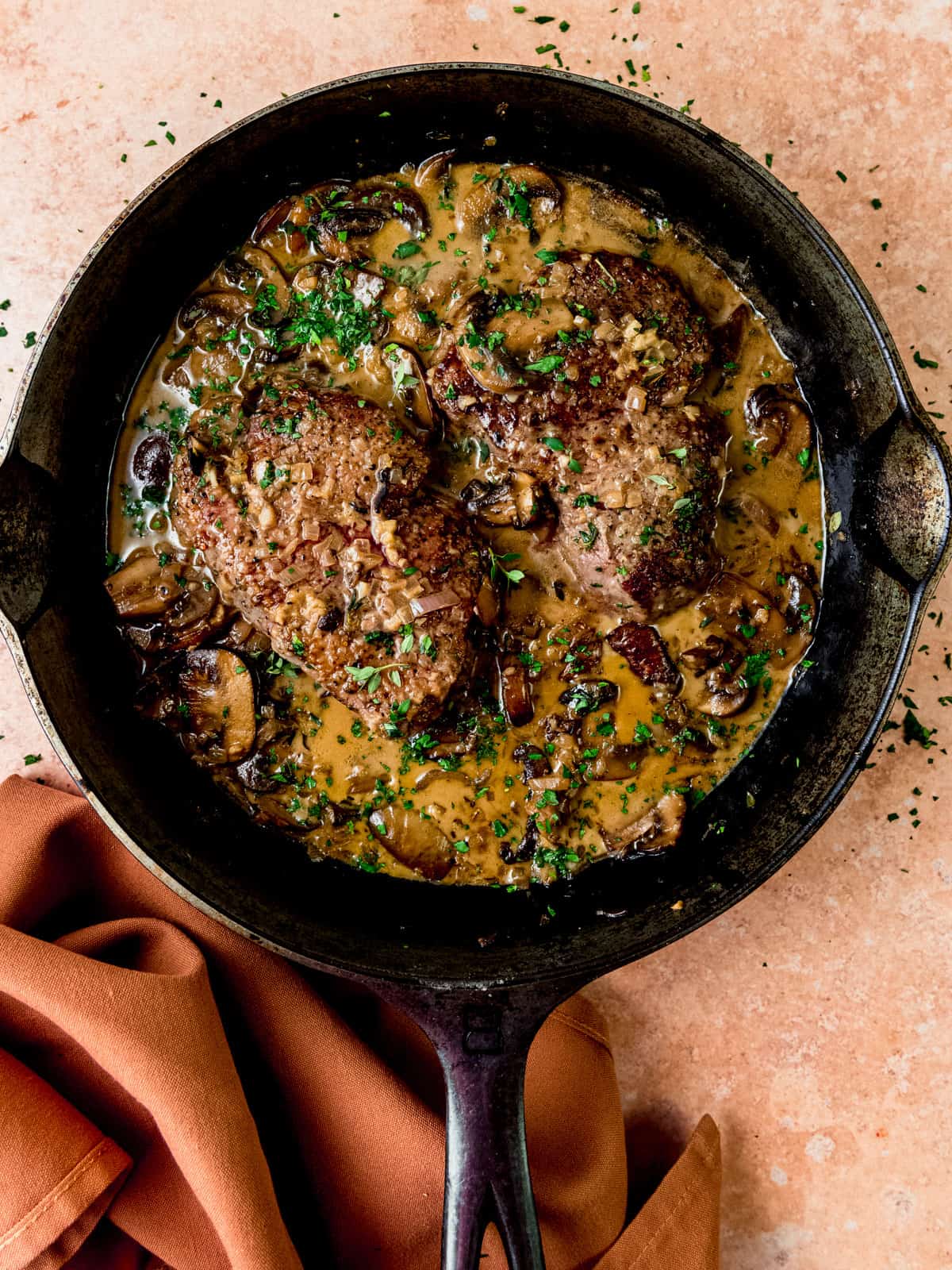 Steak marsala with mushrooms in a creamy marsala wine sauce with herbs.