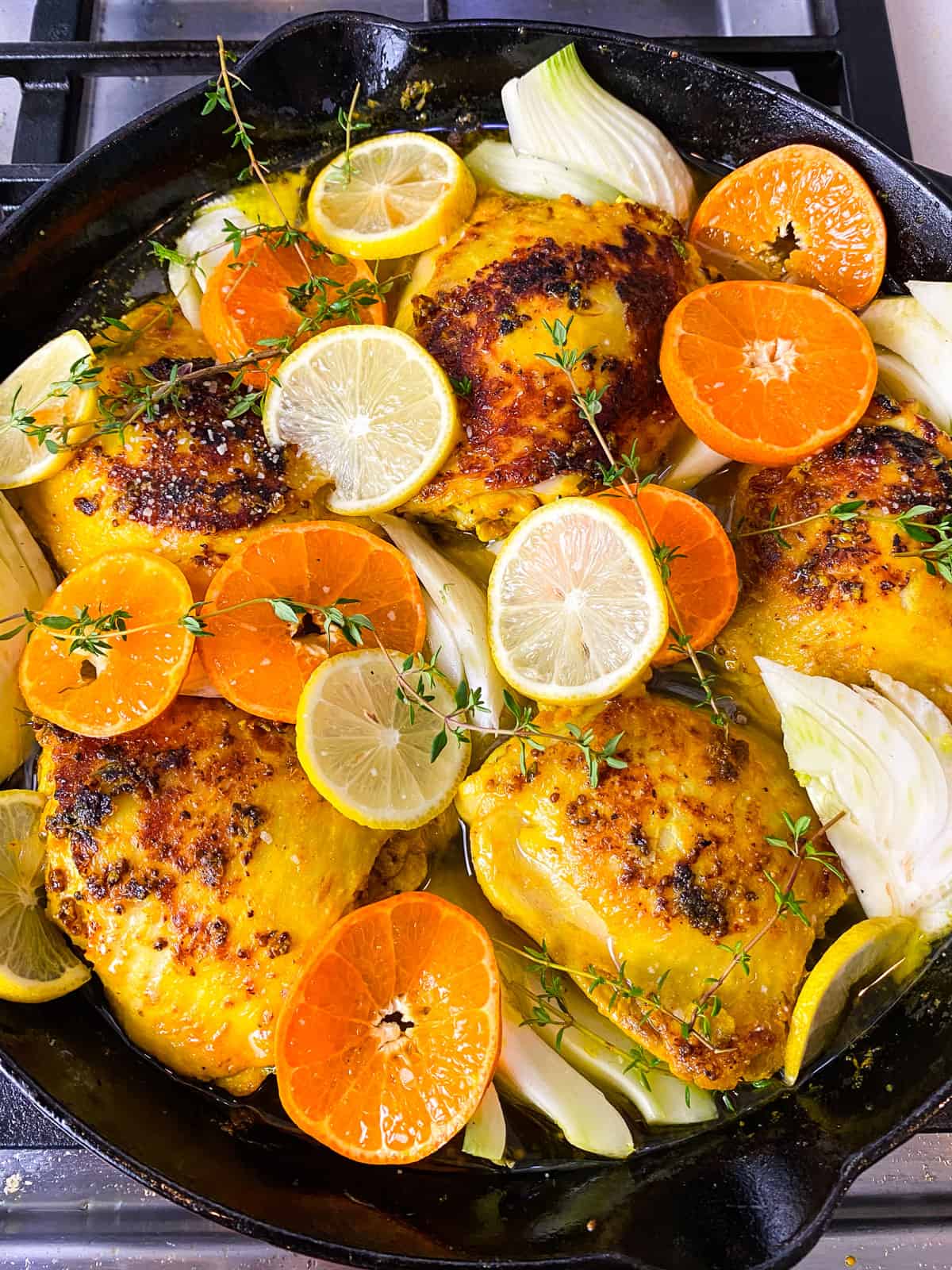 Add slices of citrus, fennel and fresh thyme to the turmeric chicken.