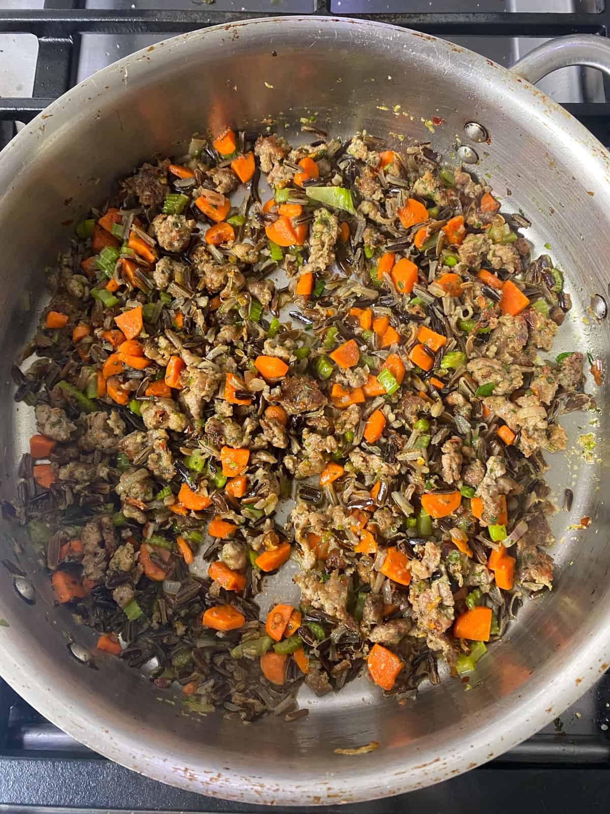 Add the cooked wild rice to the sausage and vegetable mixture and stir to combine.