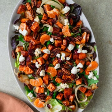 Roasted sweet potato salad with salad mix, creamy goat cheese, citrus and candied pecans.