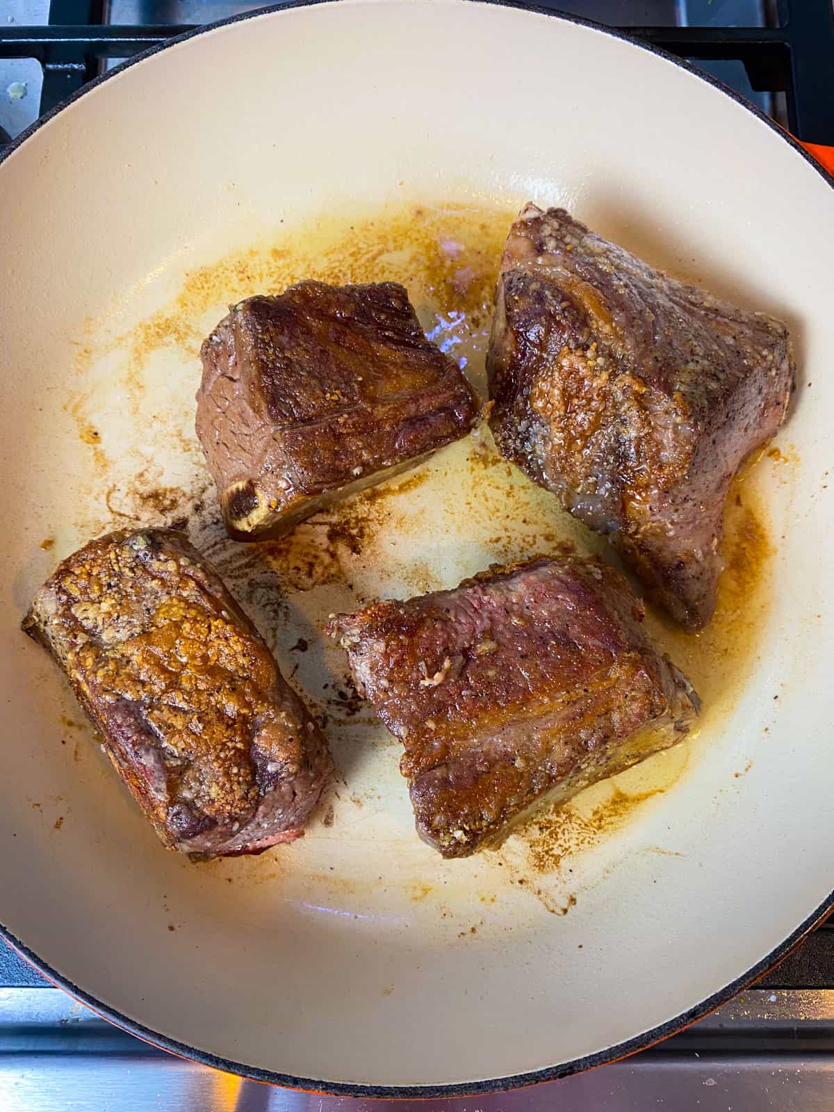 Sear the short ribs in a hot Dutch oven until deeply charred on all side.
