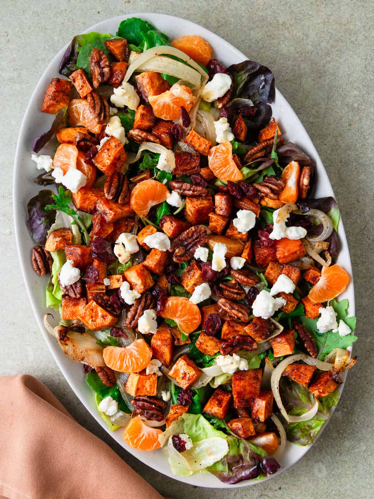 Fall sweet potato salad is layered with citrus, candied pecans and creamy goat cheese.