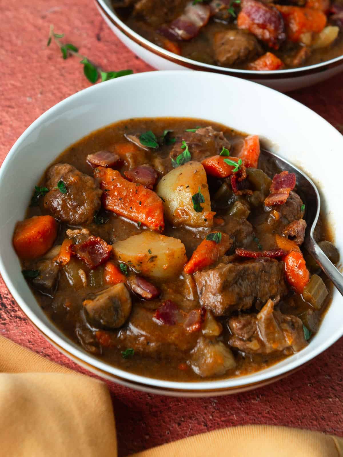 Hearty beef stew with potatoes, bacon and red wine.