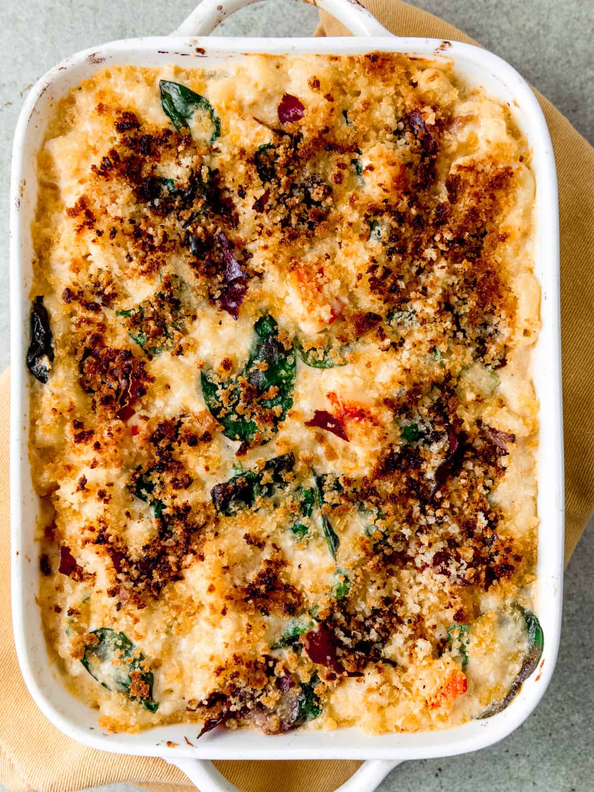 Lobster mac and cheese with prosciutto and spinach.
