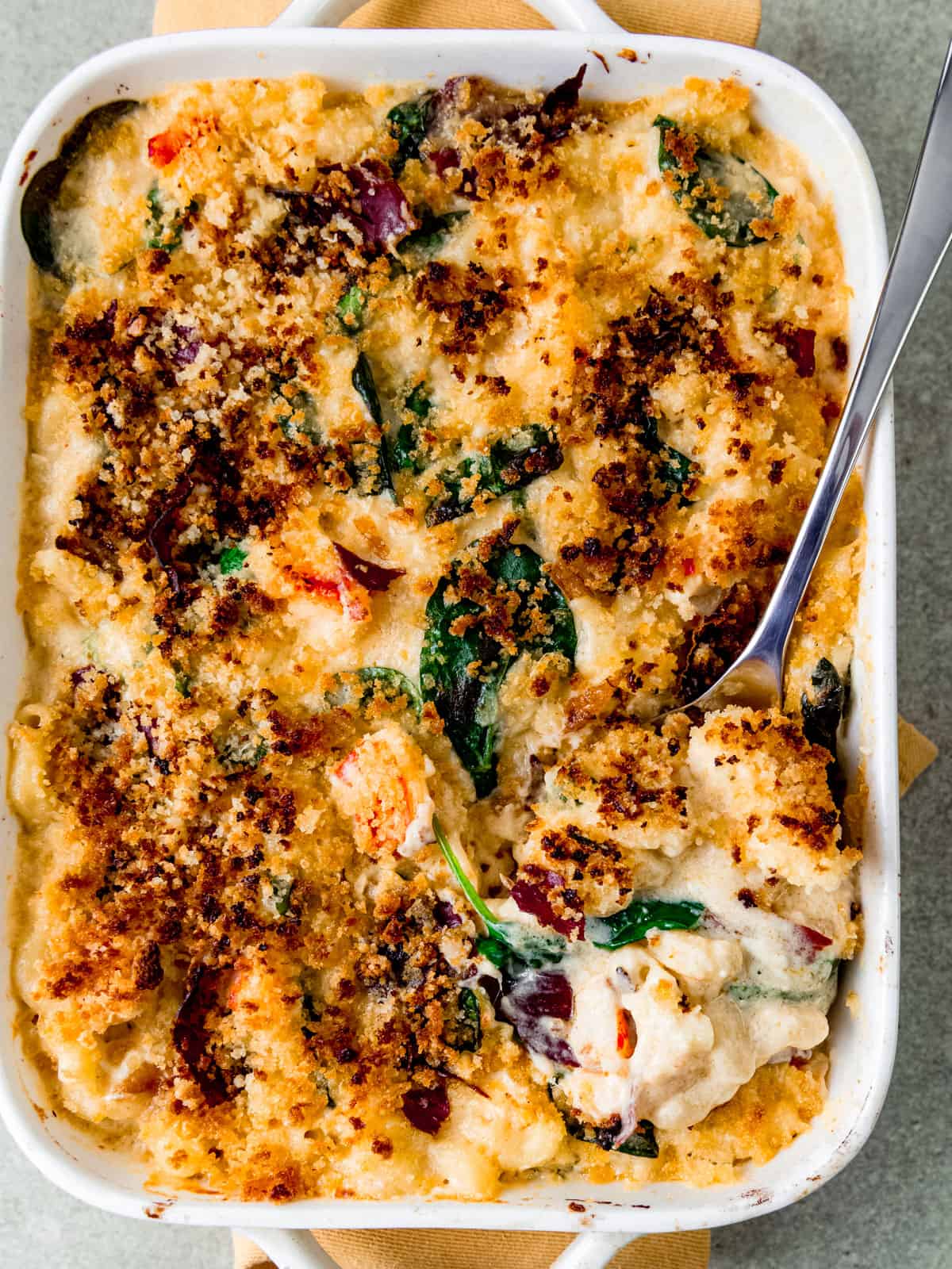 Creamy lobster mac and cheese with spinach, crispy prosciutto and panko breadcrumb topping.
