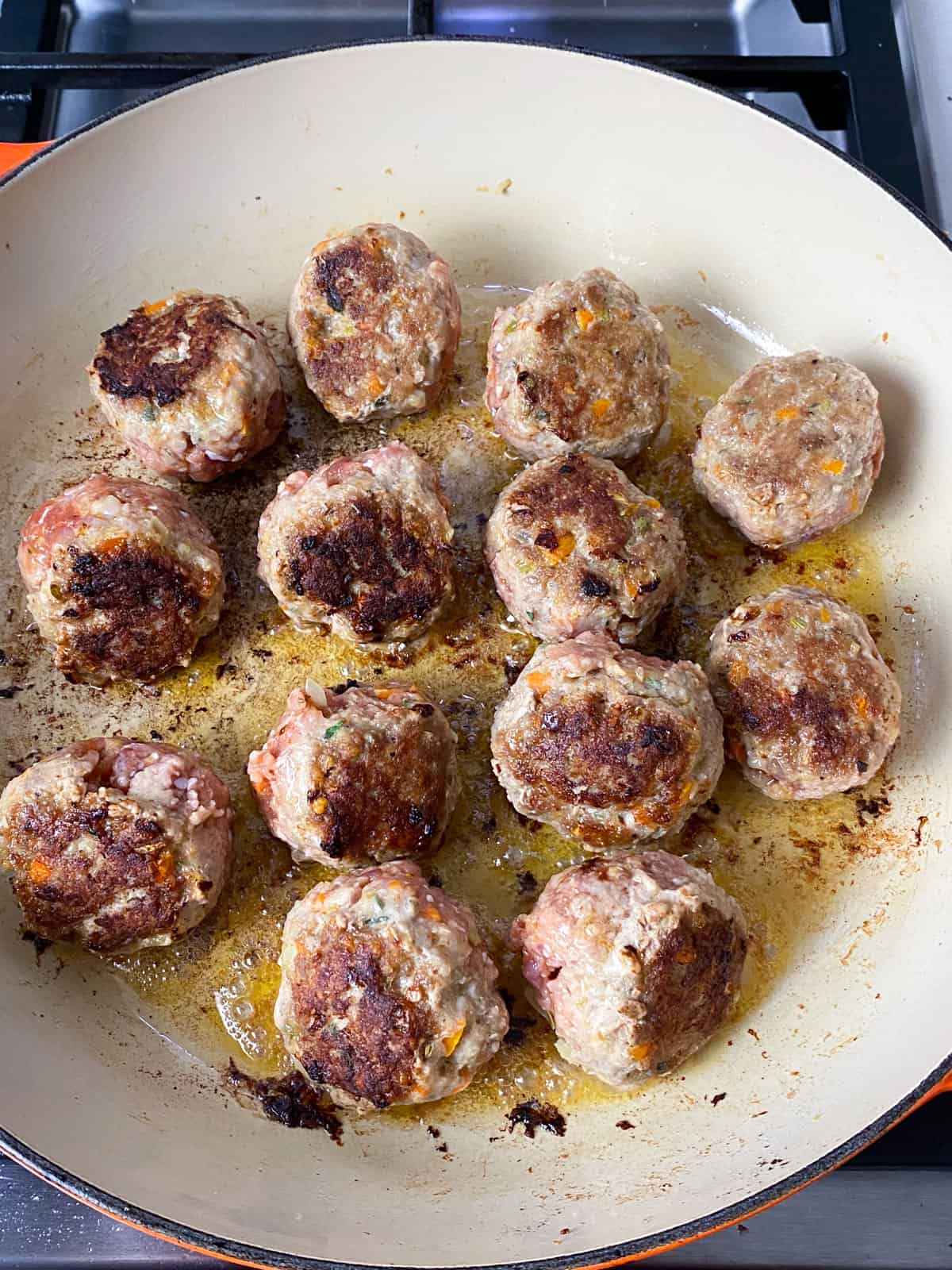 Sear the turkey and sausage meatballs on all sides until deeply charred.