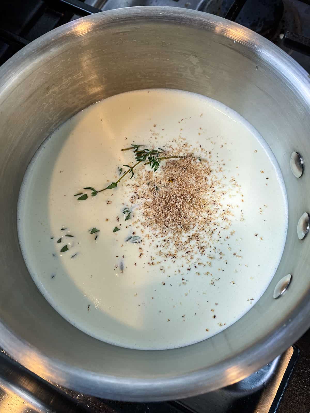 Steep fresh thyme, nutmeg and garlic in heavy cream and heat to warm through.
