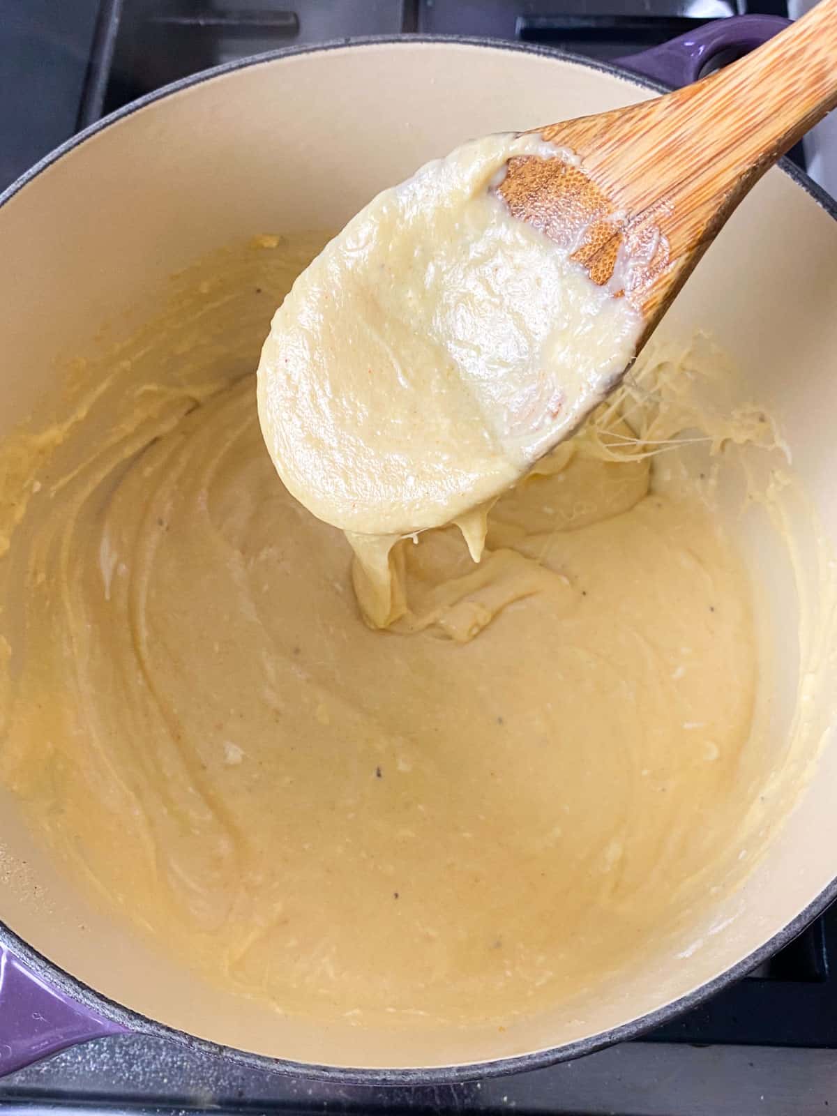 Whisk the shredded cheeses into the bechamel sauce until the cheese has melted and sauce thickens.