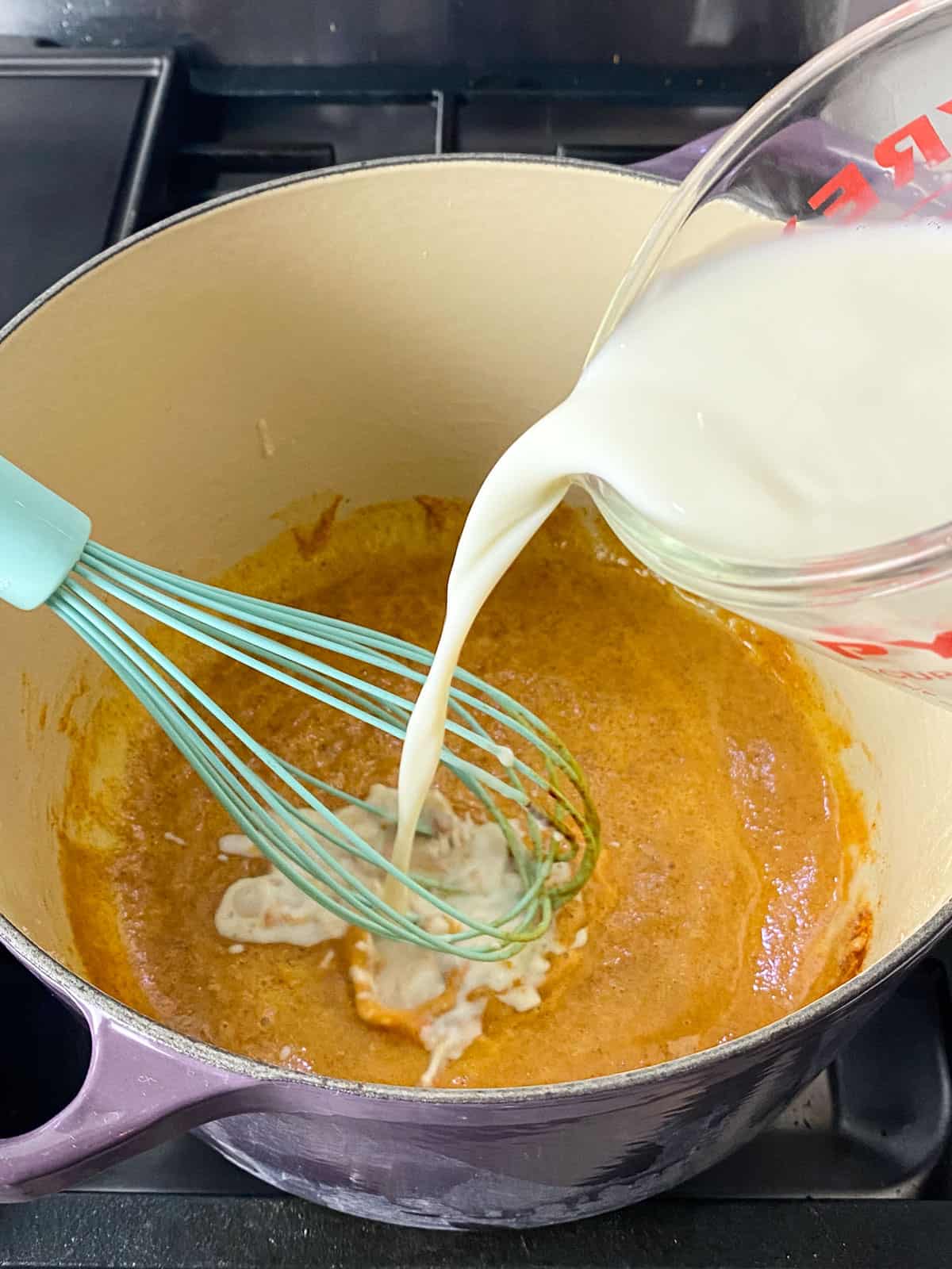 Slowly whisk in milk into the roux mixture.